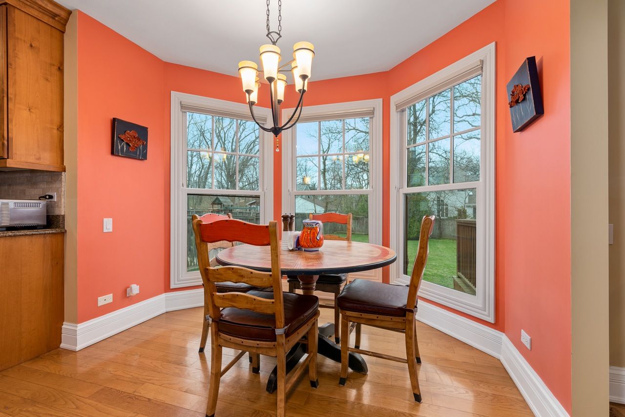 A dining room with a table and chairs and a chandelier.