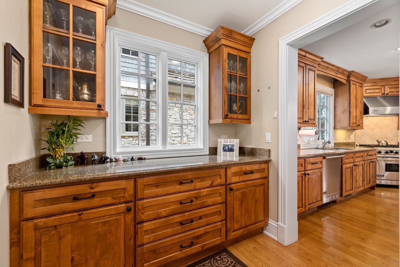 A kitchen with wooden cabinets and granite counter tops.