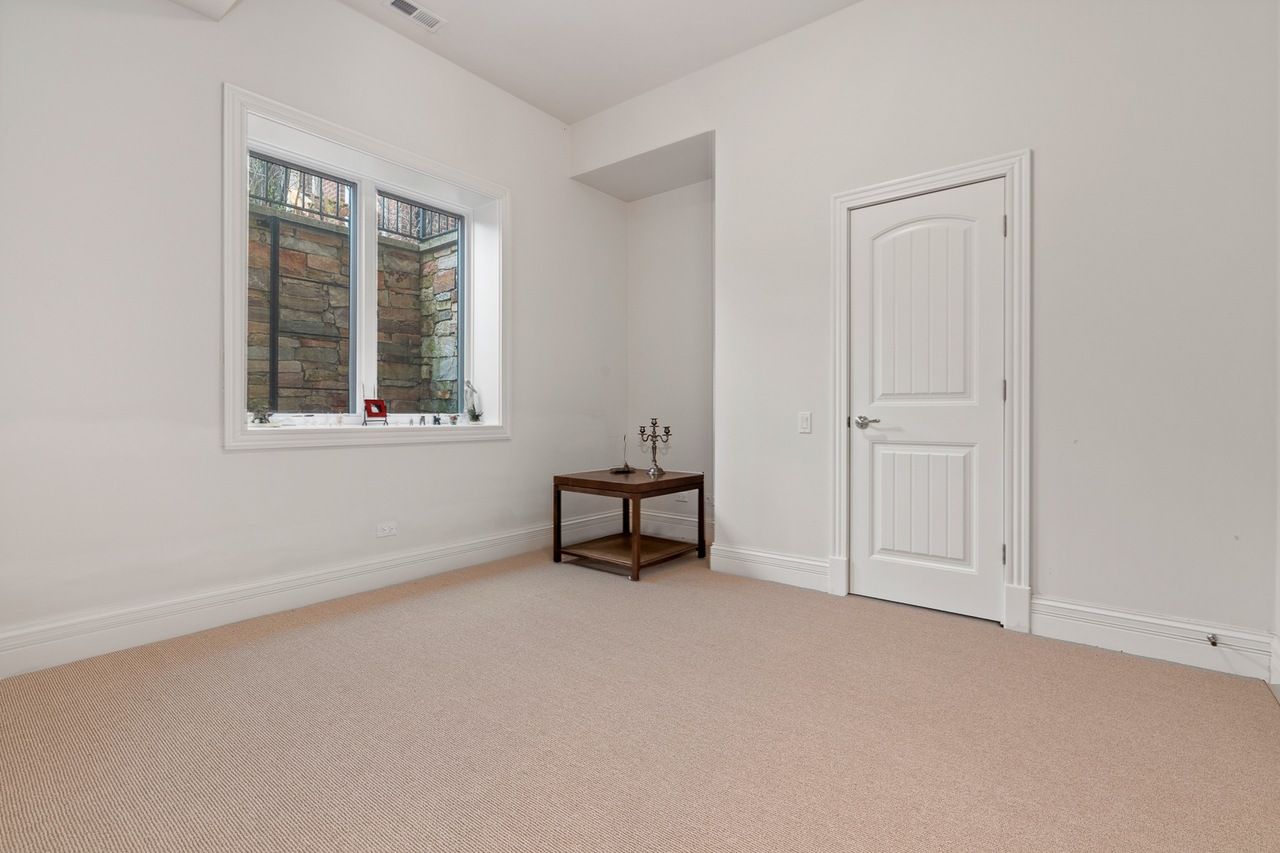 An empty room with a table and a window.