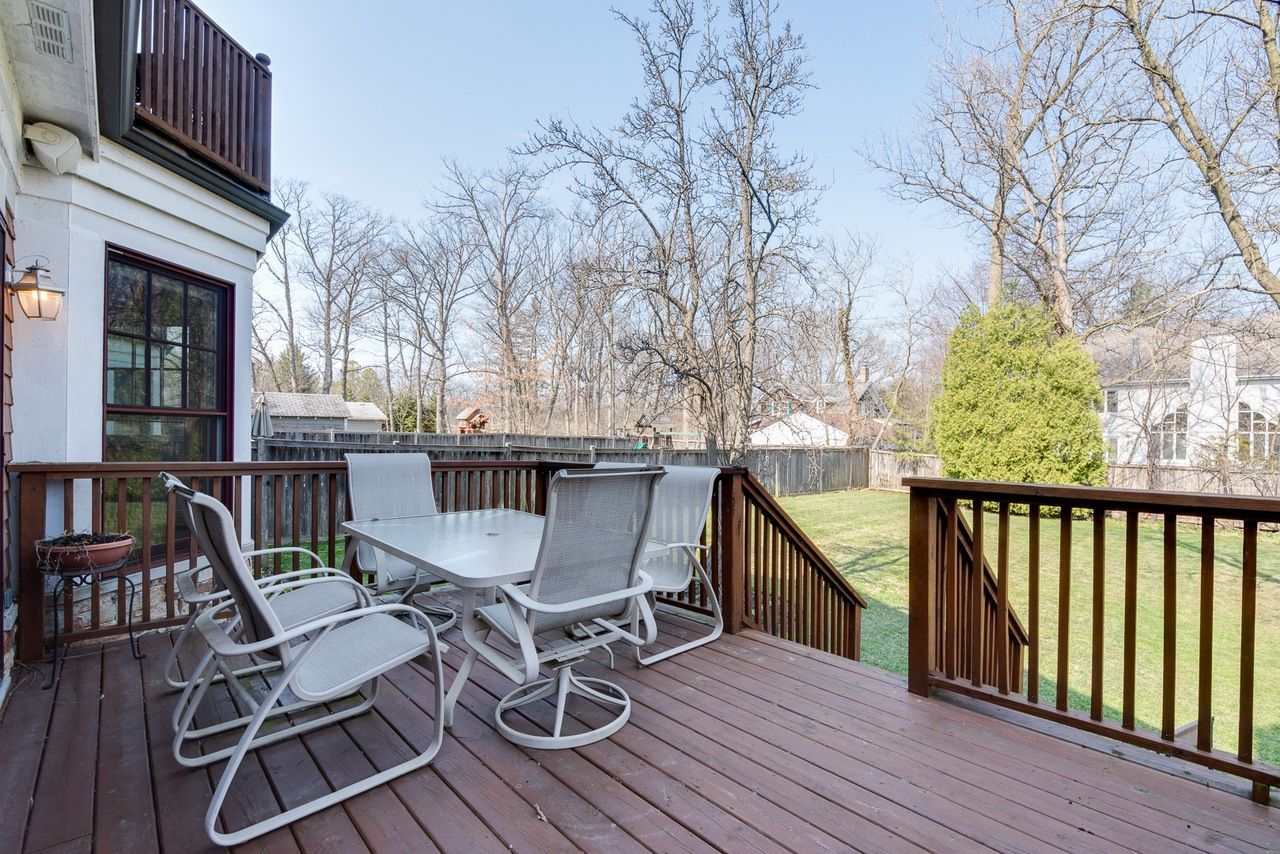 A wooden deck with a table and chairs on it.