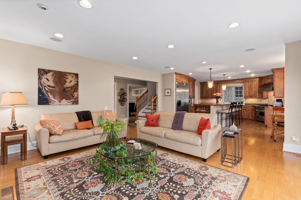 A living room with two couches , a coffee table , and a rug.