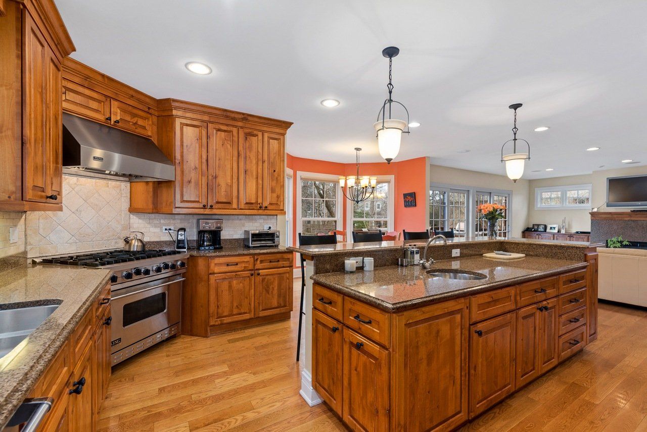 A kitchen with wooden cabinets and granite counter tops
