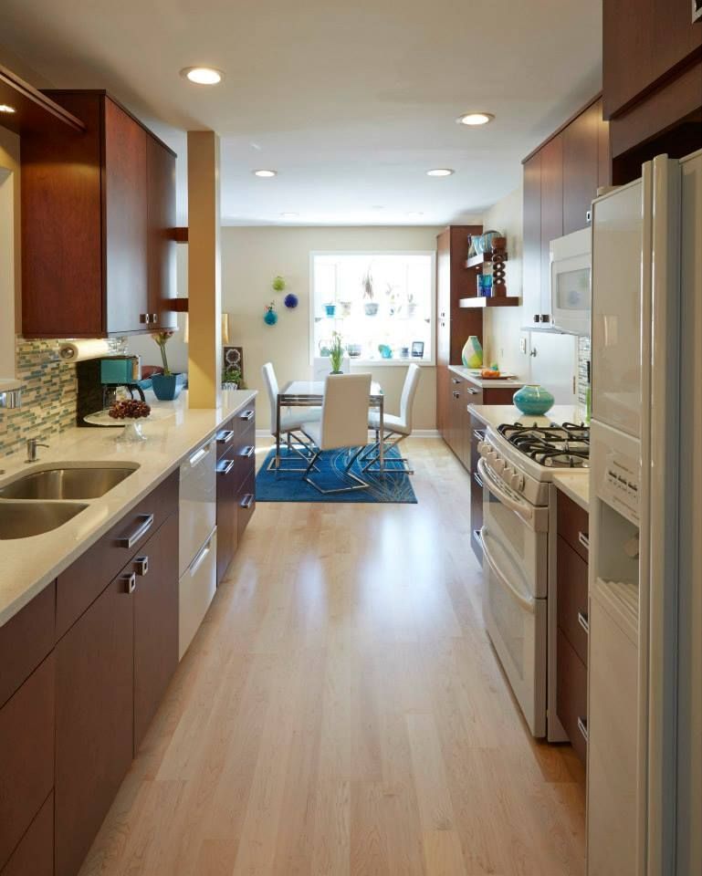 A kitchen with a stove a sink and a refrigerator