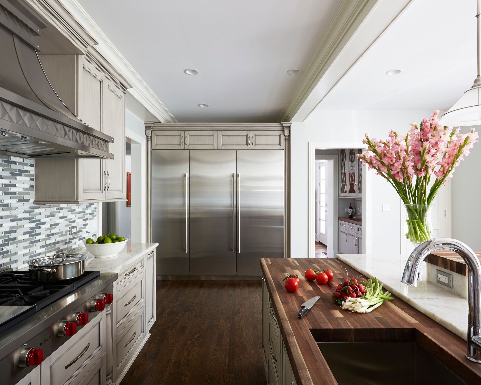 A kitchen with stainless steel appliances and a wooden counter top