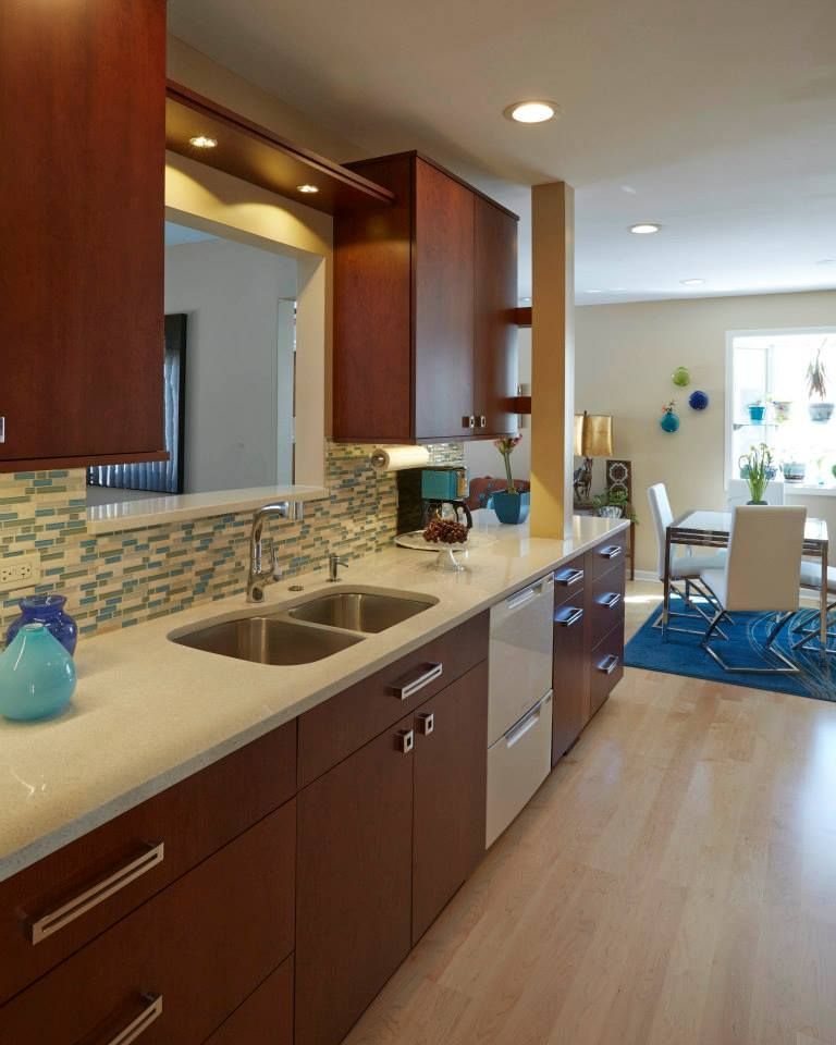 A kitchen with two sinks and a blue vase on the counter