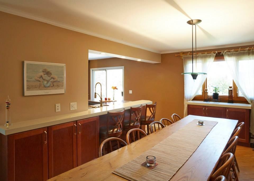A kitchen with a long wooden table and chairs