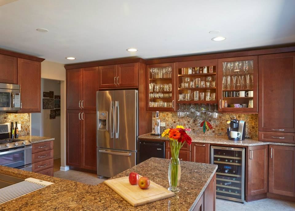 A kitchen with stainless steel appliances and wooden cabinets