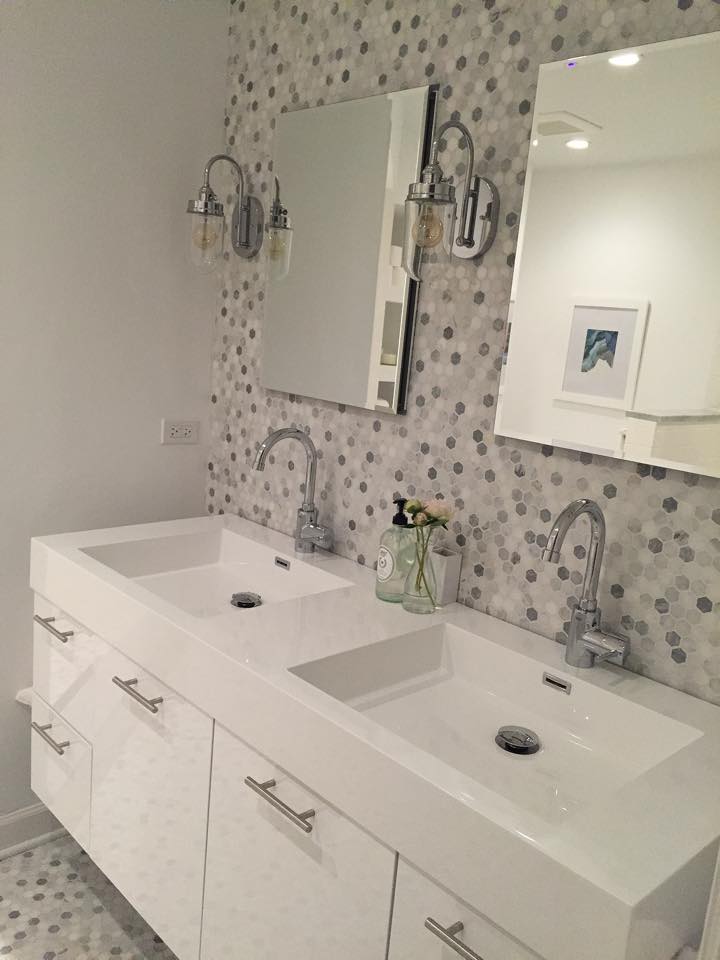 A bathroom with two sinks and a mirror.