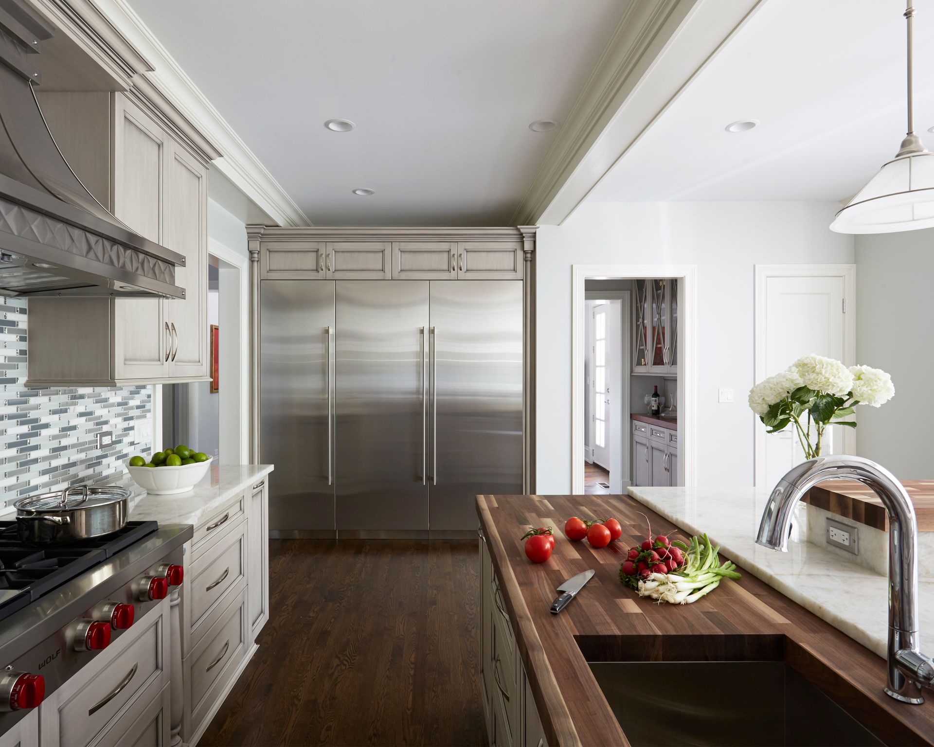 A kitchen with stainless steel appliances and a wooden counter top
