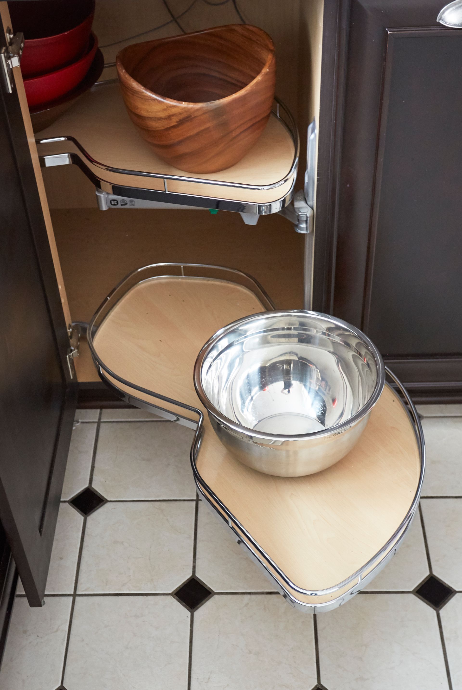 Two bowls are sitting on a shelf in a kitchen