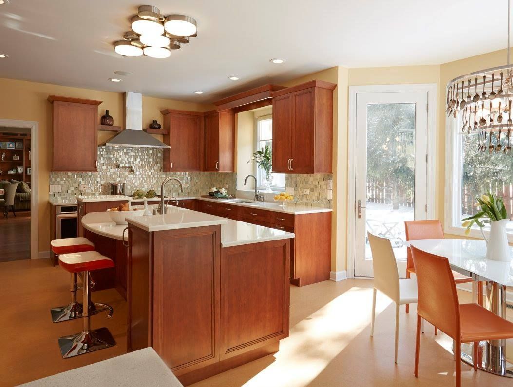 A kitchen with wooden cabinets and white counter tops