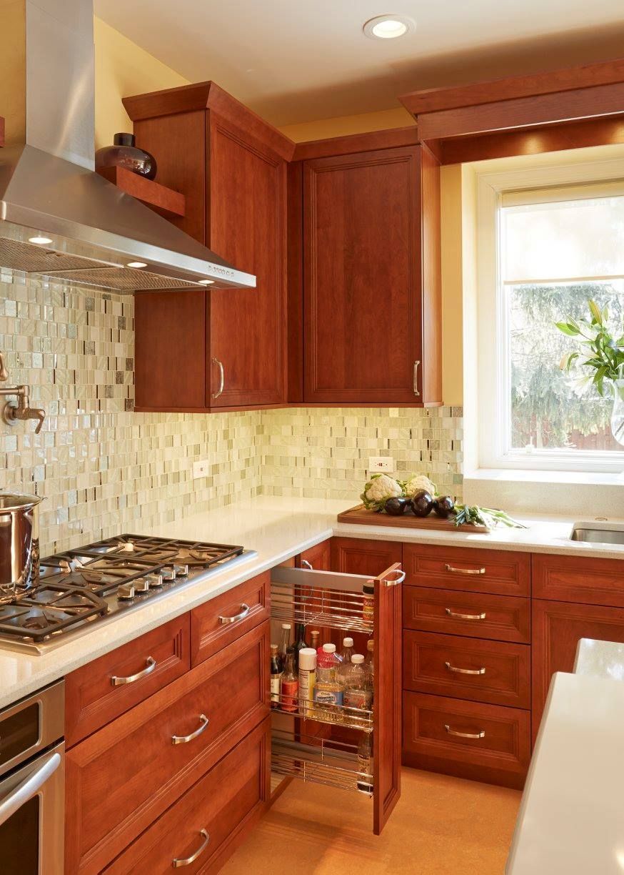 A kitchen with wooden cabinets and a stove top oven