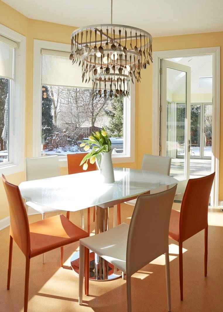 A dining room with a table and chairs and a chandelier