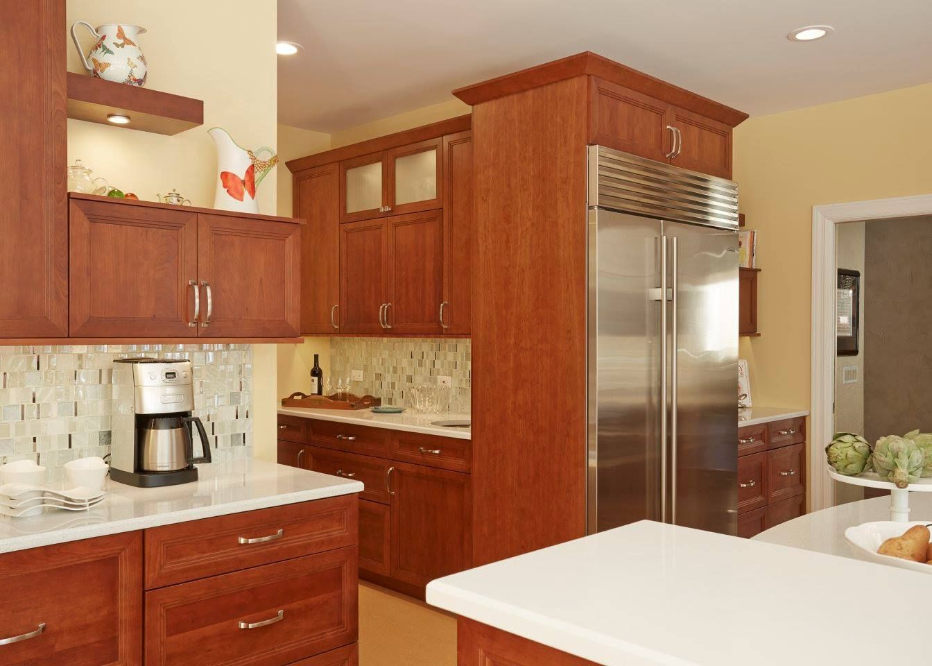 A kitchen with stainless steel appliances and wooden cabinets