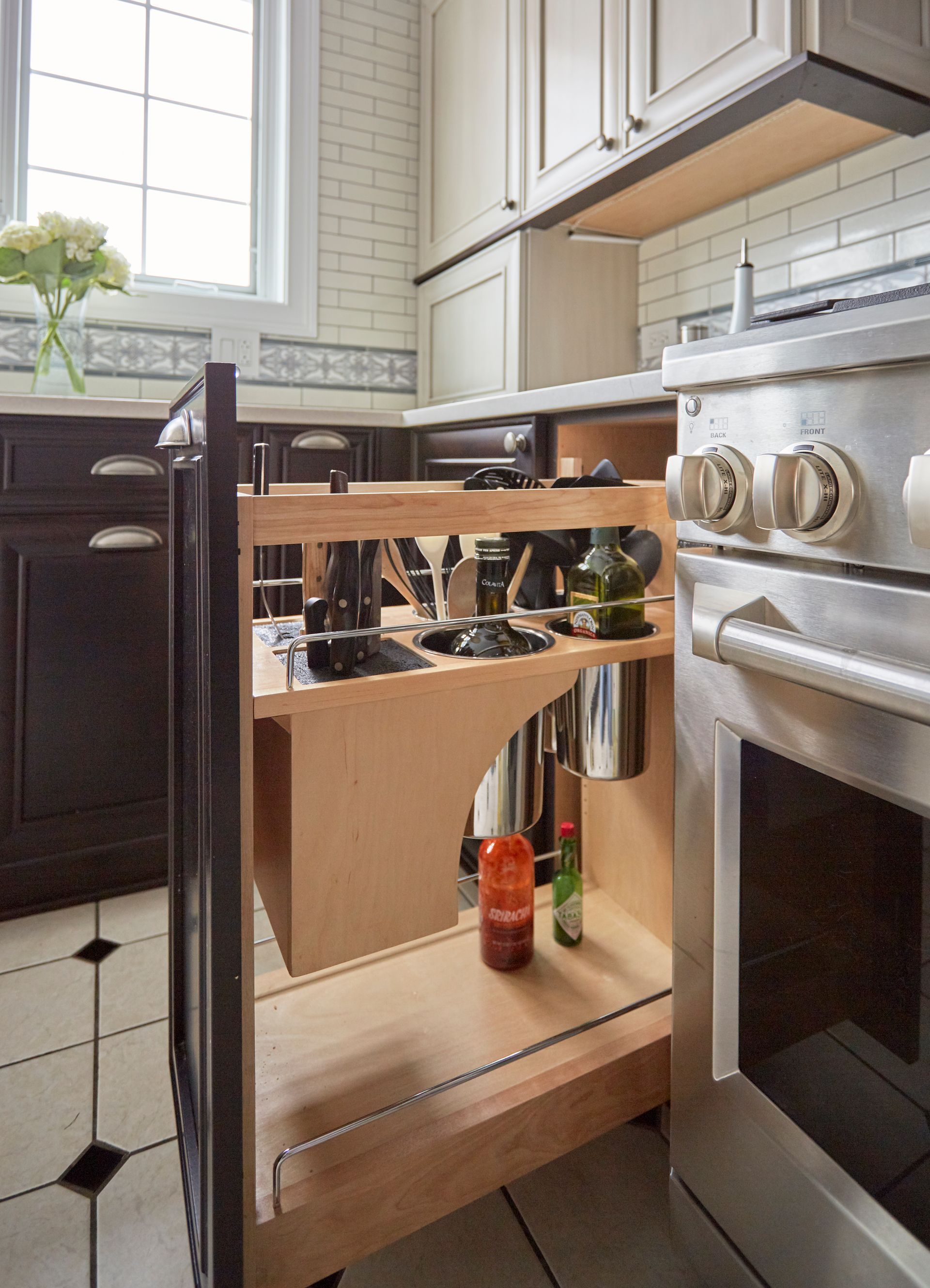 A kitchen with a pull out spice rack and a stove