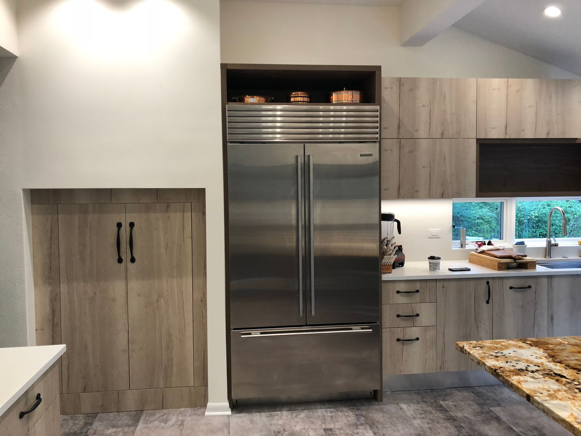 A kitchen with stainless steel appliances and wooden cabinets