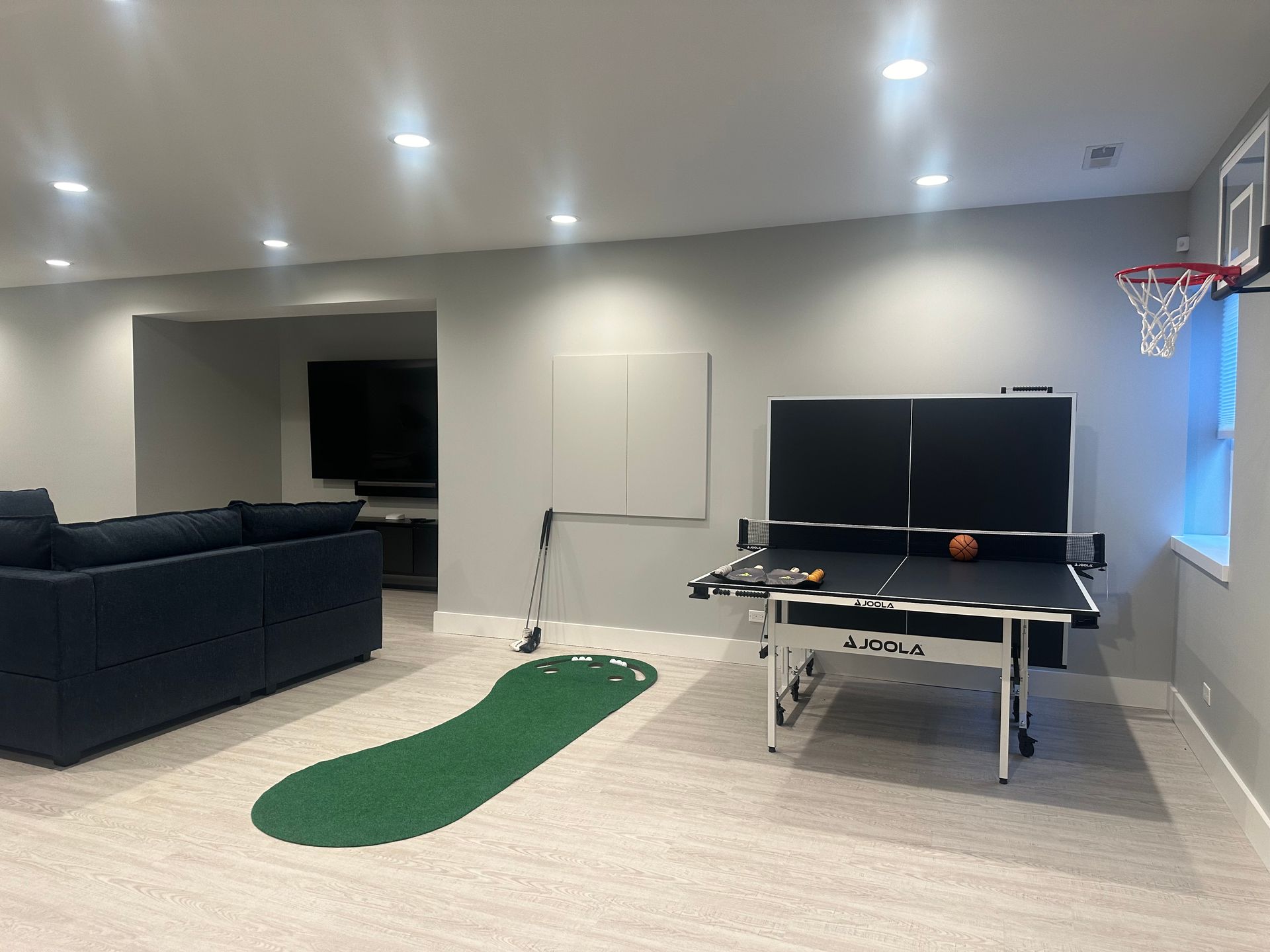 There is a ping pong table in the middle of the room.