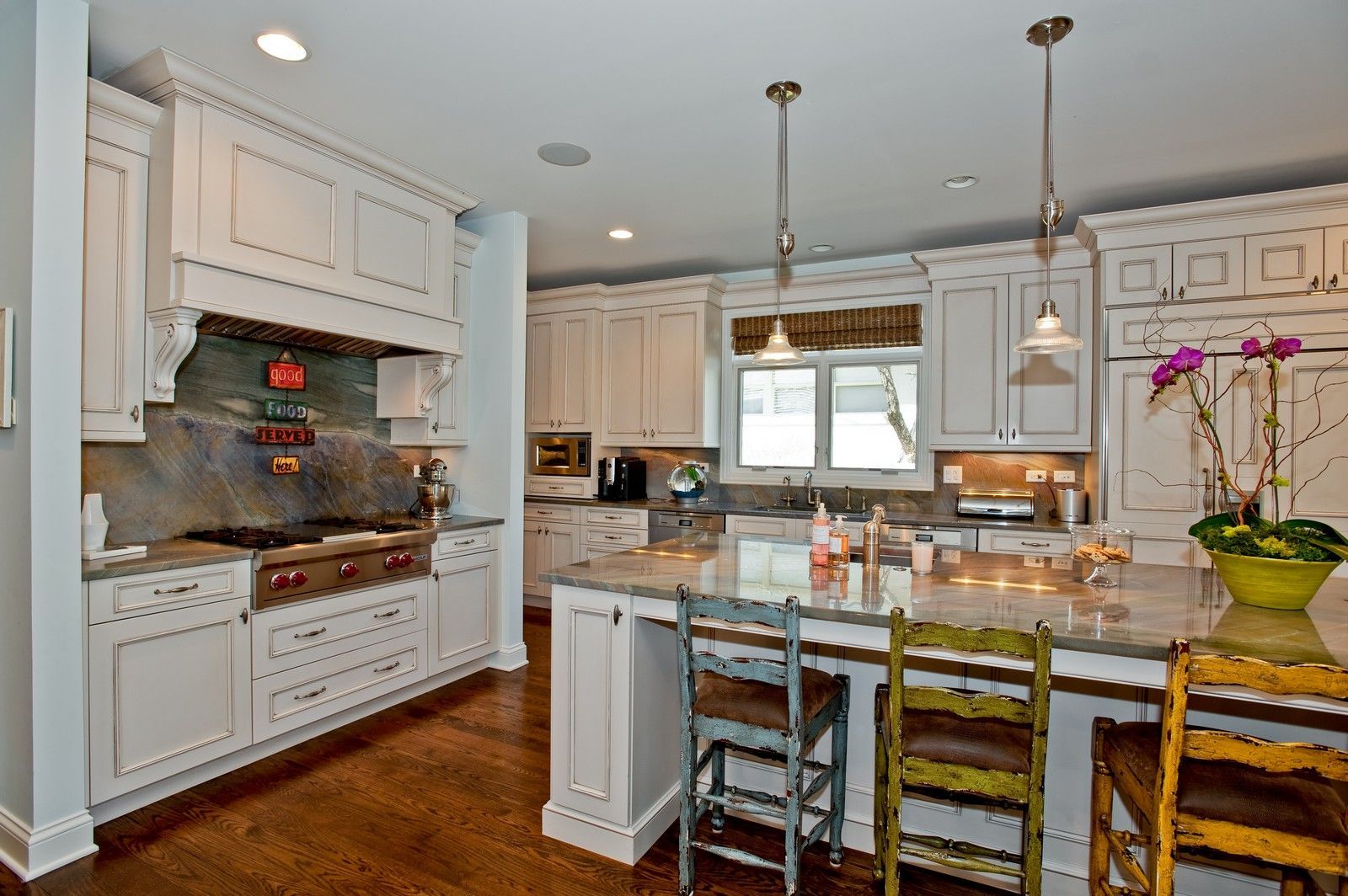 A kitchen with white cabinets and a large island