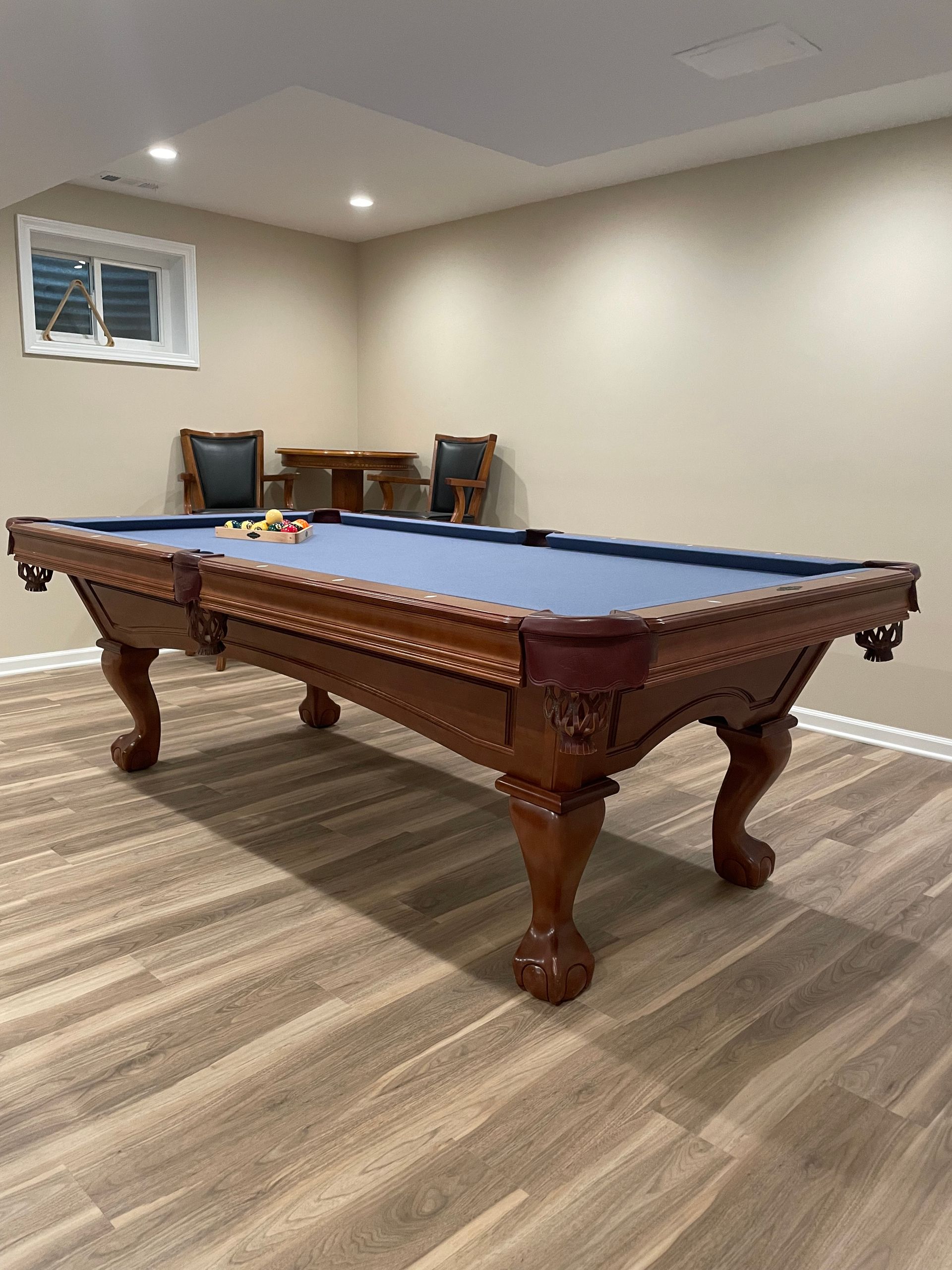 There is a pool table in the middle of the room.