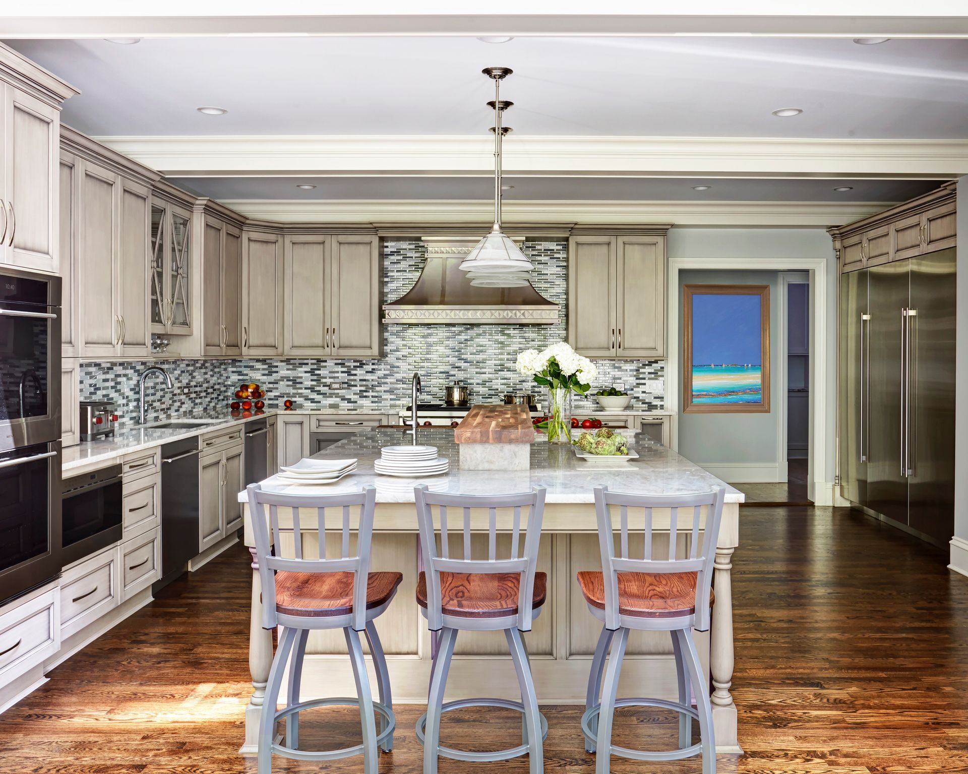 A kitchen with a large island and stools
