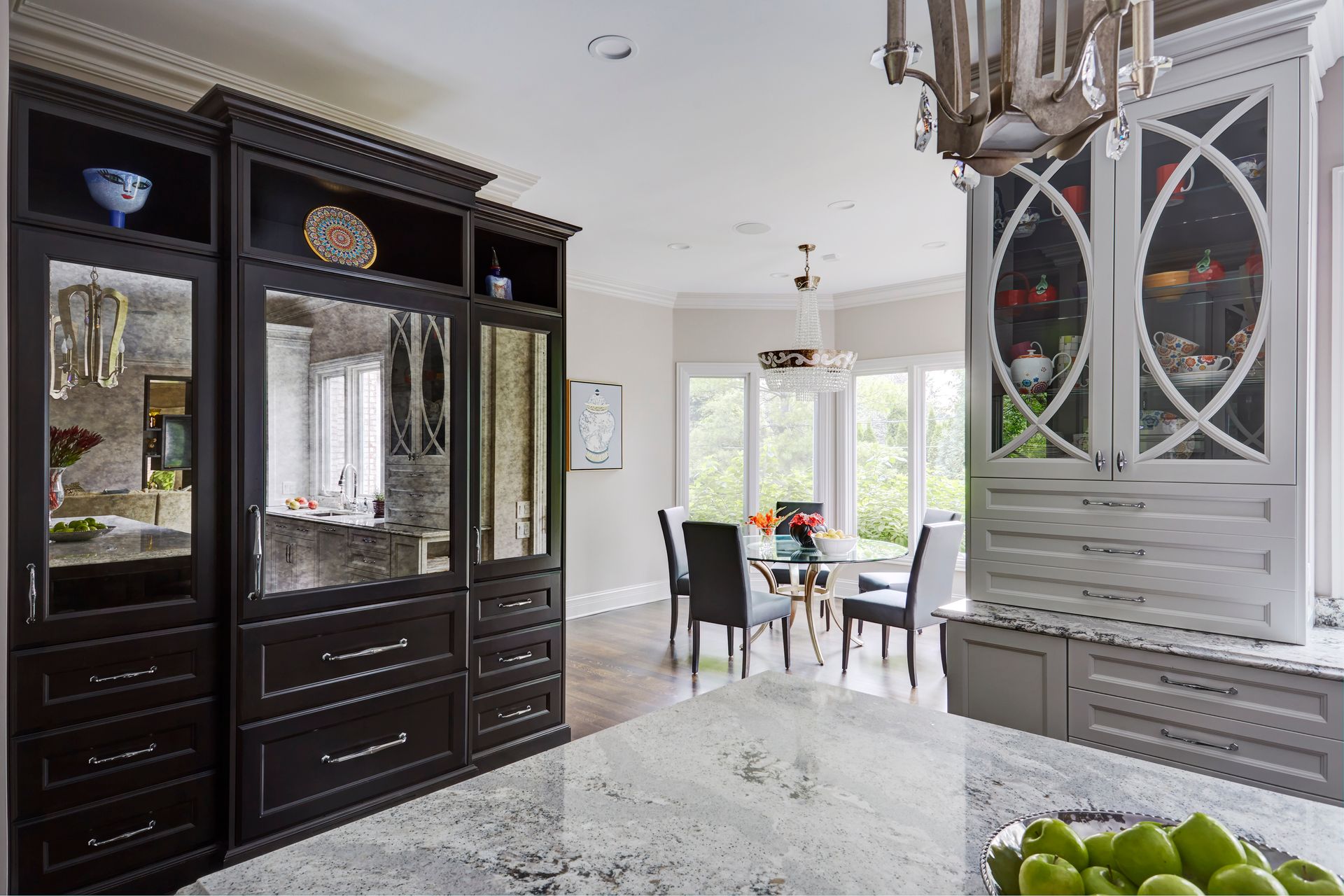 A kitchen with lots of cabinets and a dining room in the background.
