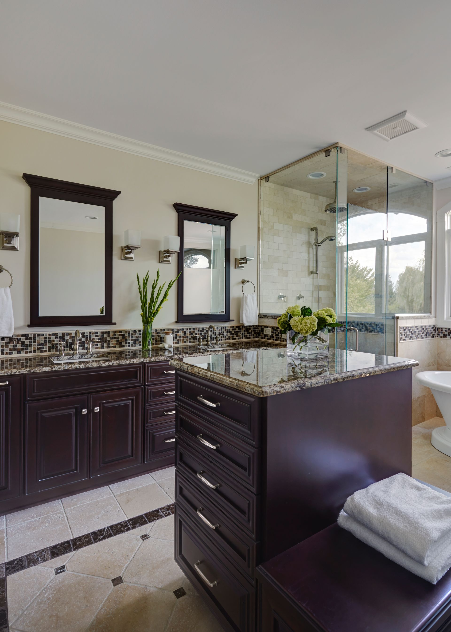 A bathroom with two sinks and two mirrors