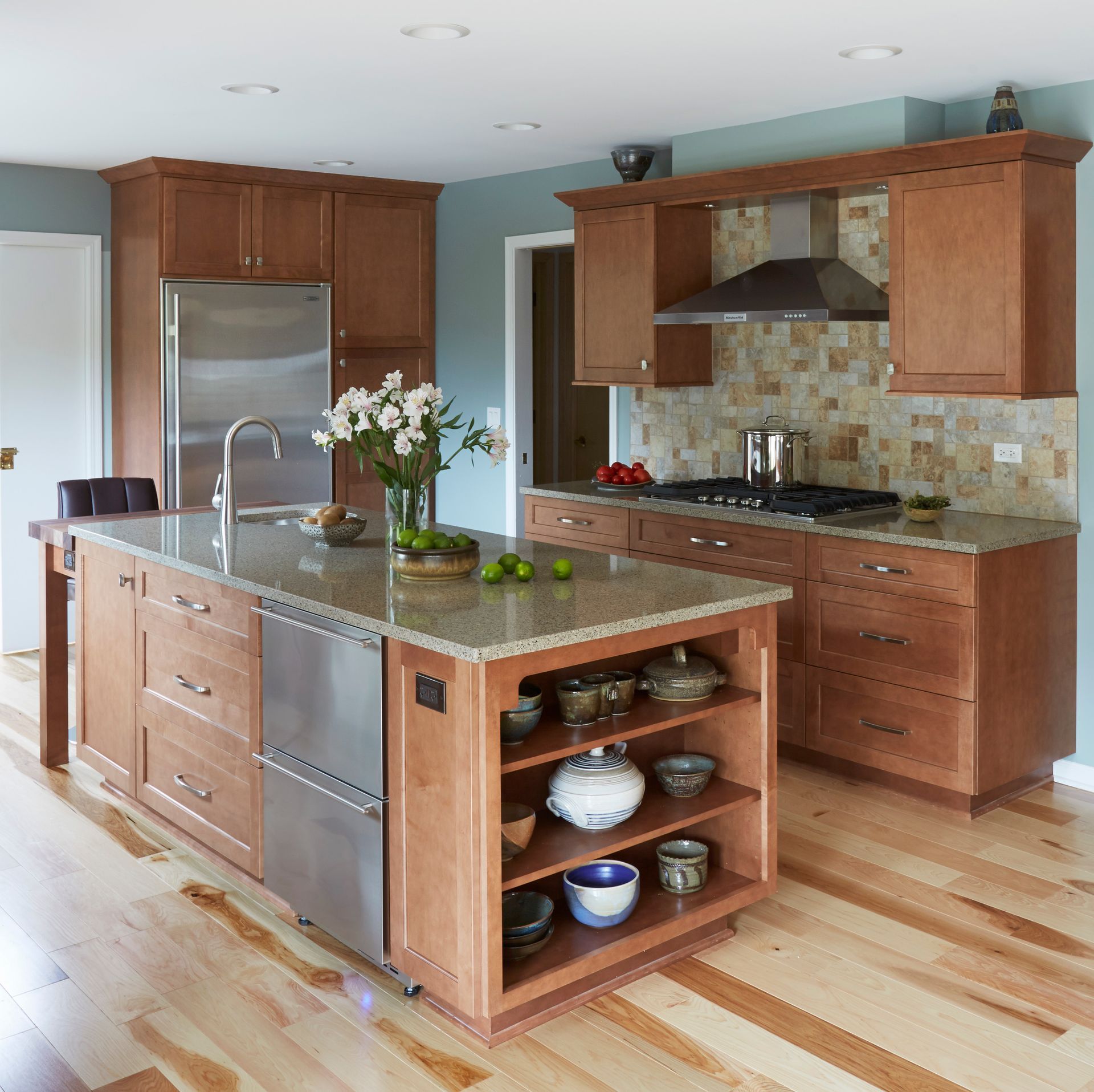 A kitchen with stainless steel appliances and wooden cabinets