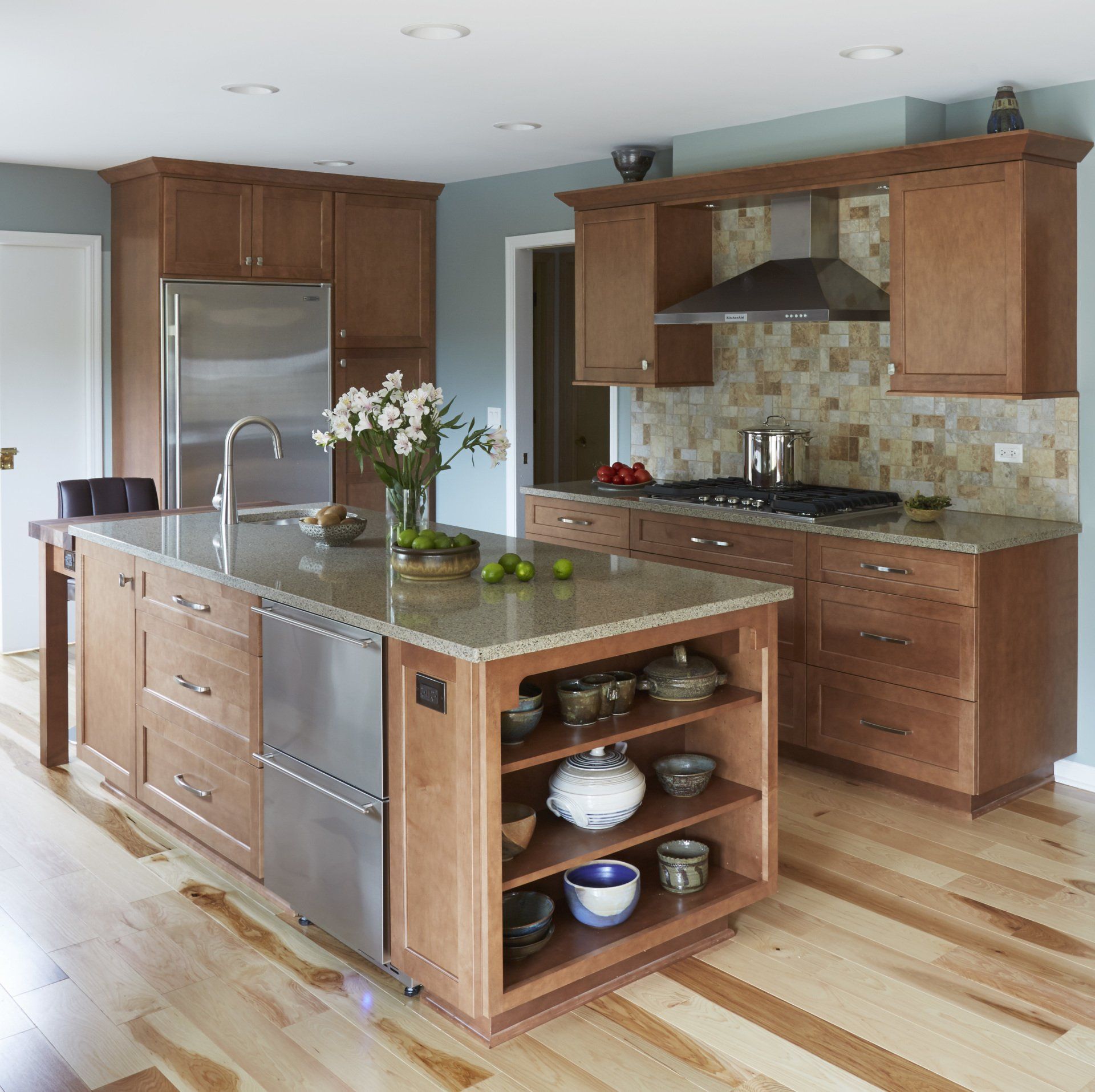 A kitchen with stainless steel appliances and wooden cabinets