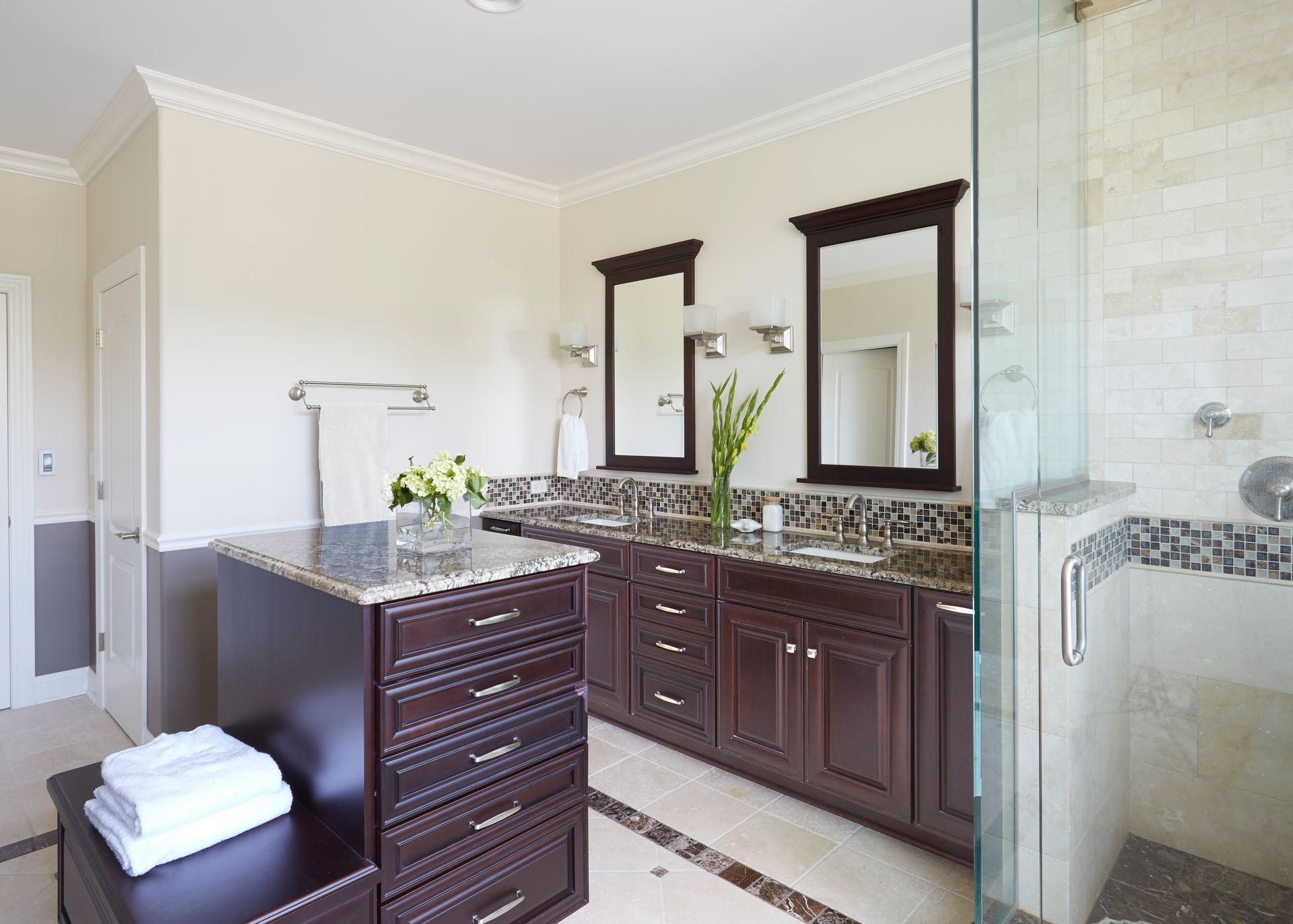 A bathroom with two sinks and a walk in shower