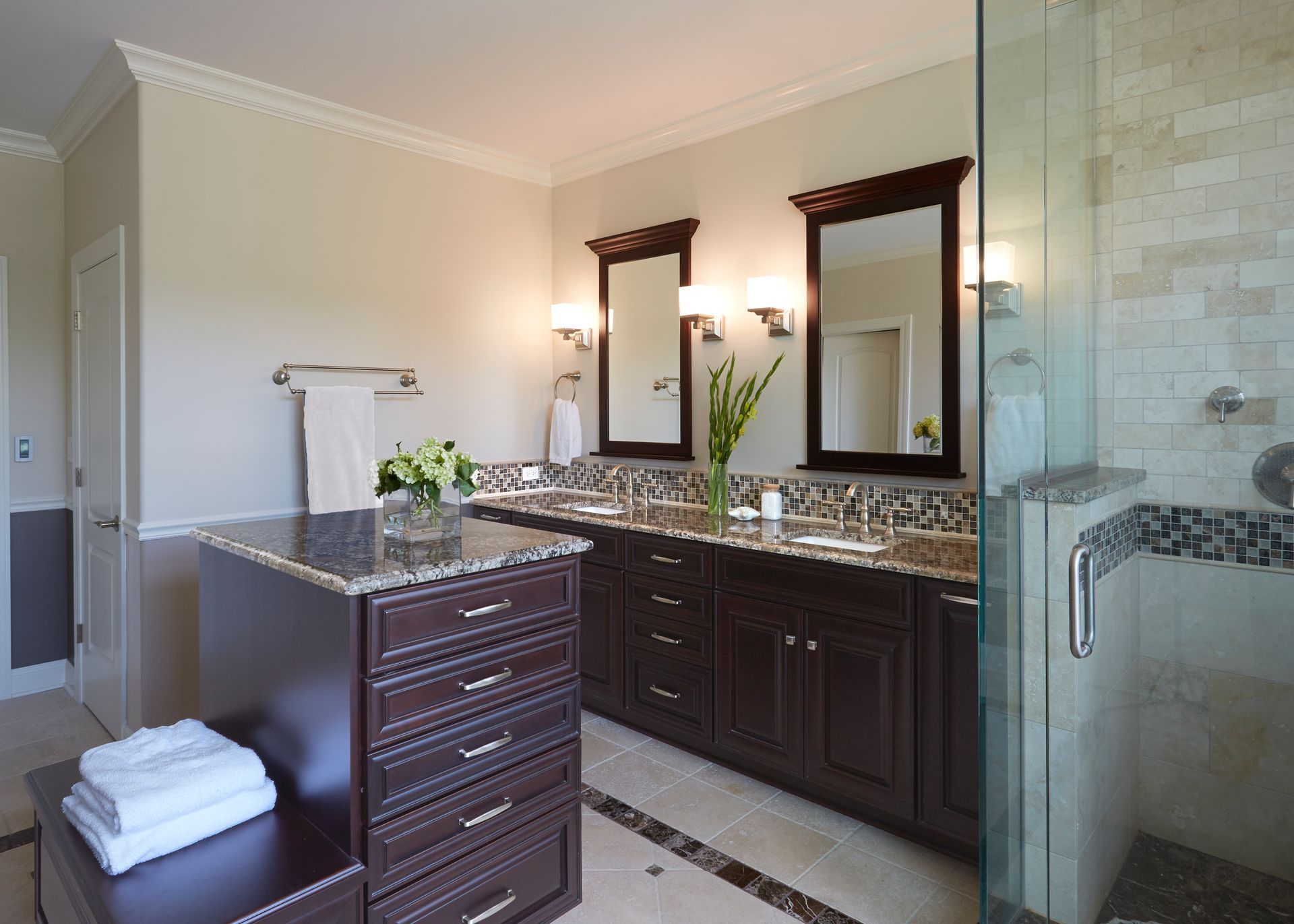A bathroom with two sinks and a walk in shower