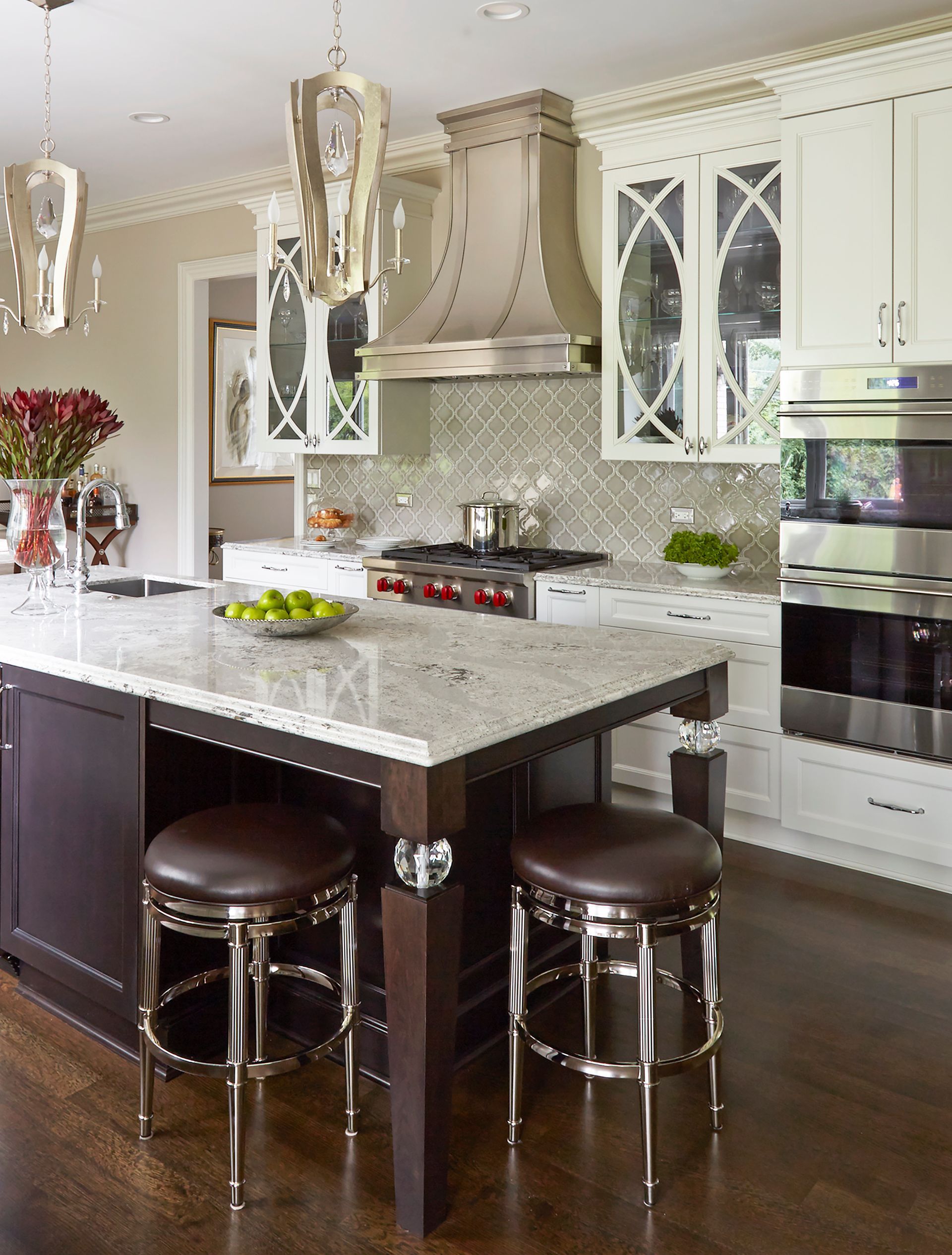 A kitchen with a large island and stools