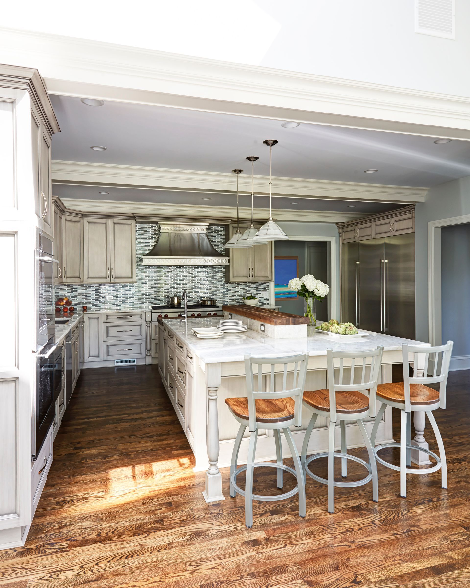 A kitchen with a large island and stools