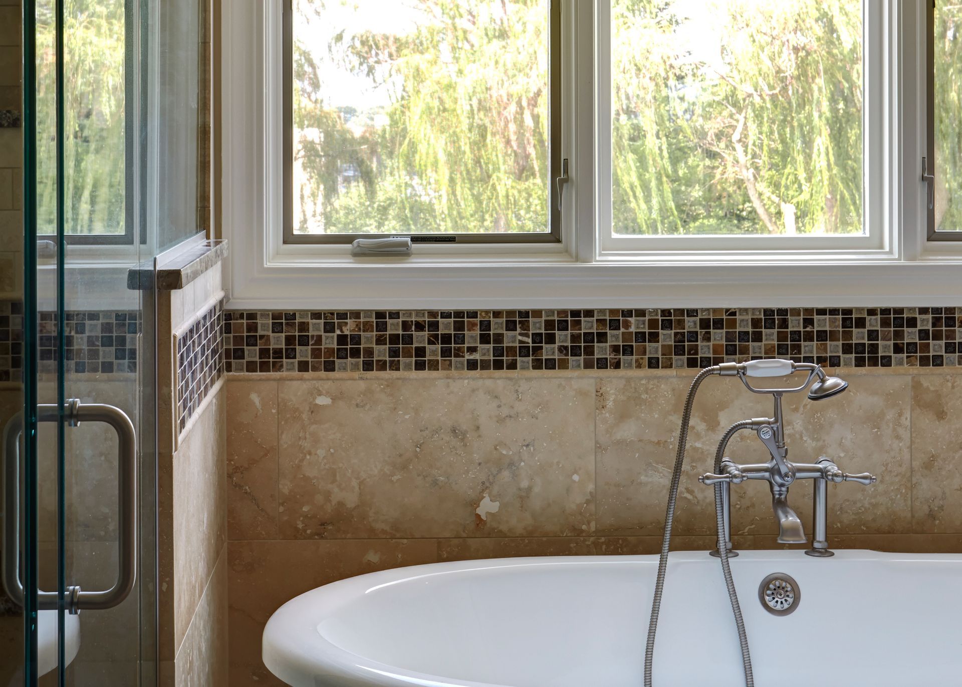 A bathroom with a bathtub and a window.