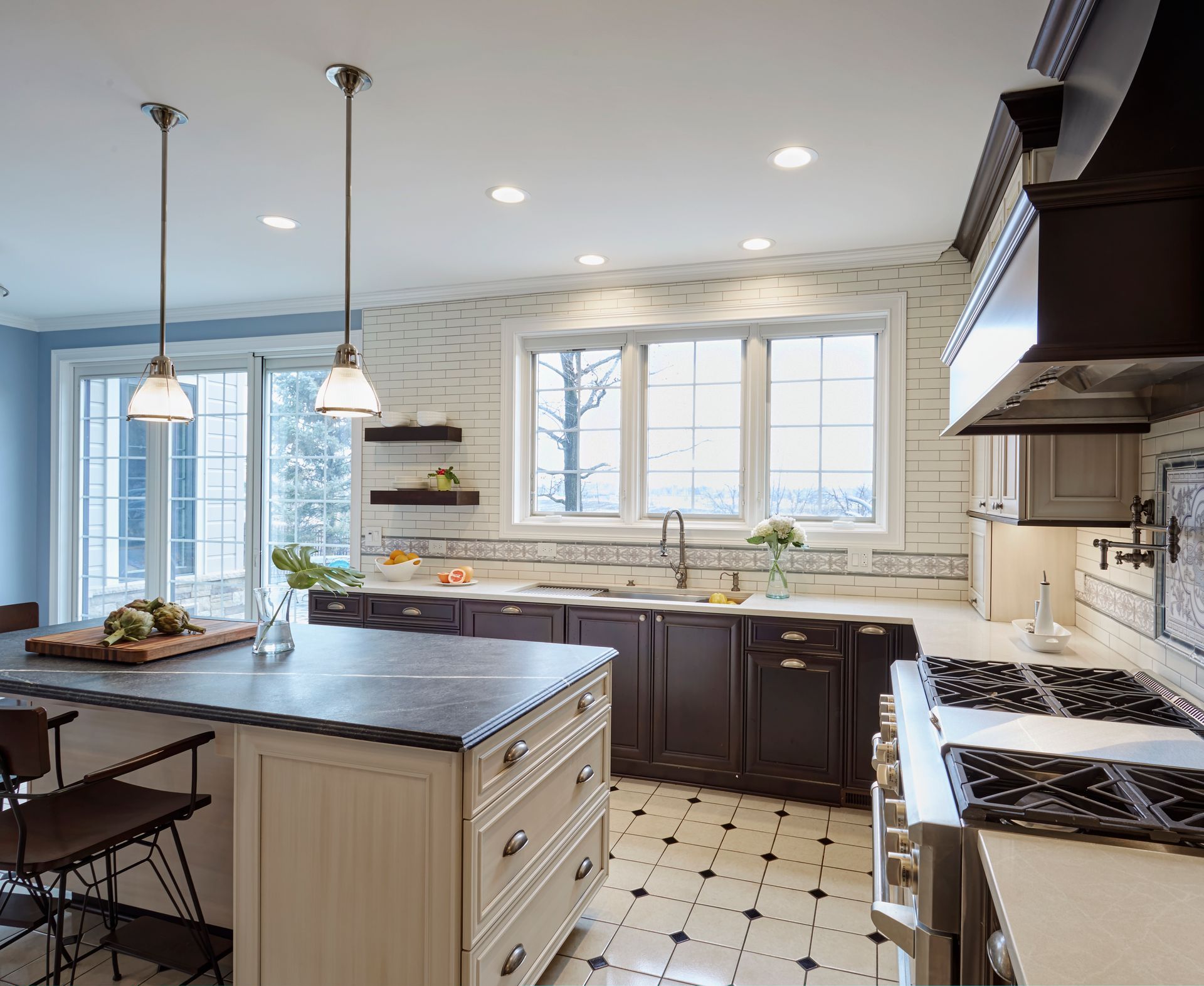 A kitchen with a large island and a stove top oven