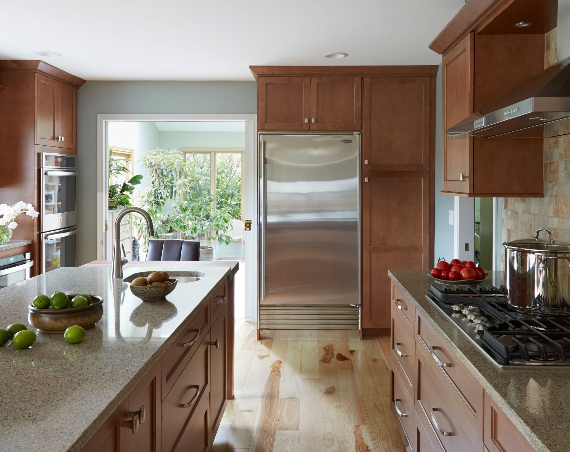 A kitchen with stainless steel appliances and wooden cabinets