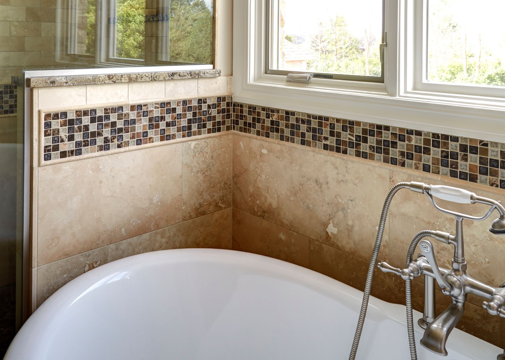 A bathtub in a bathroom next to a window