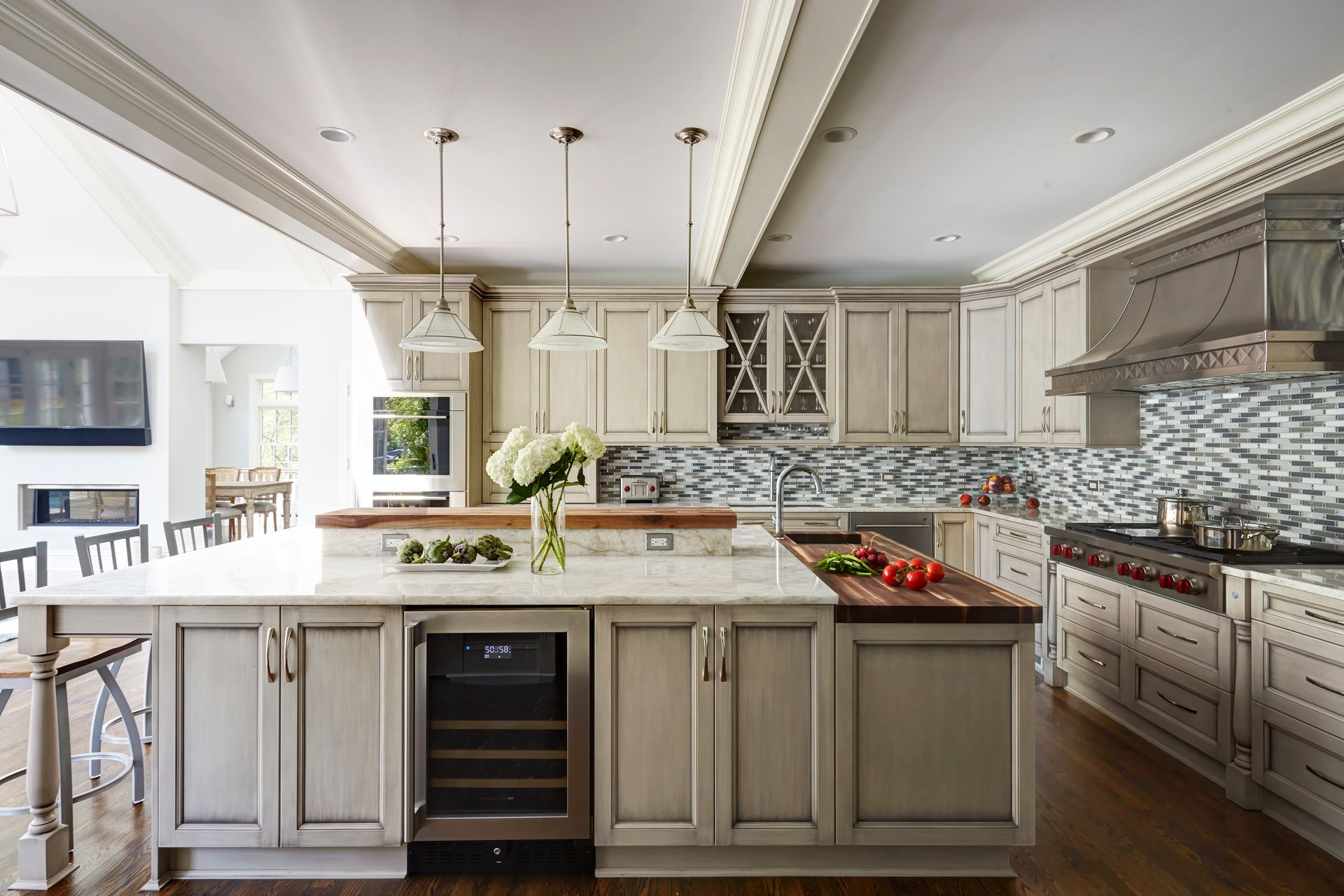 A kitchen with white cabinets and a large island in the middle.