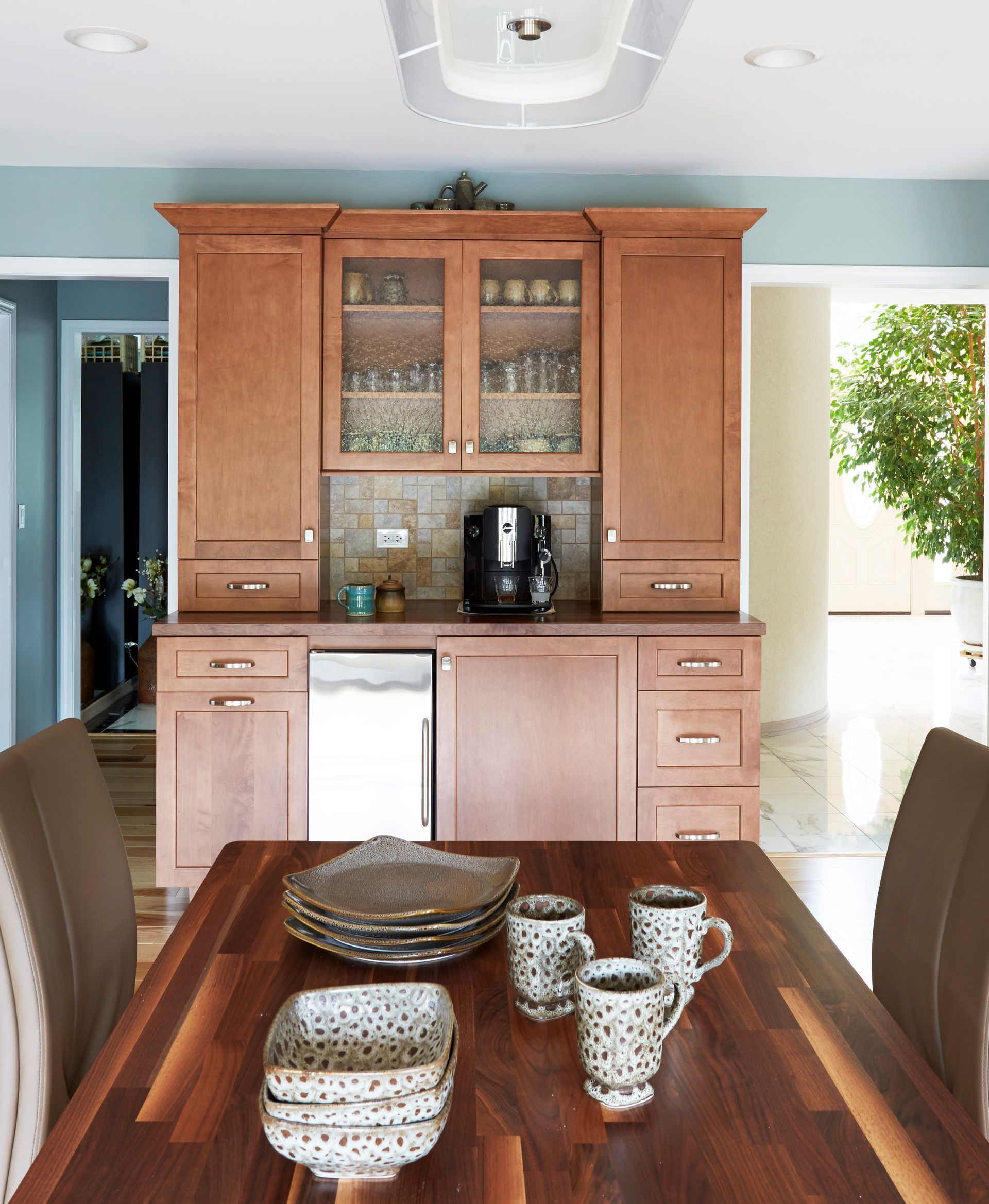 A dining room table with plates and cups on it