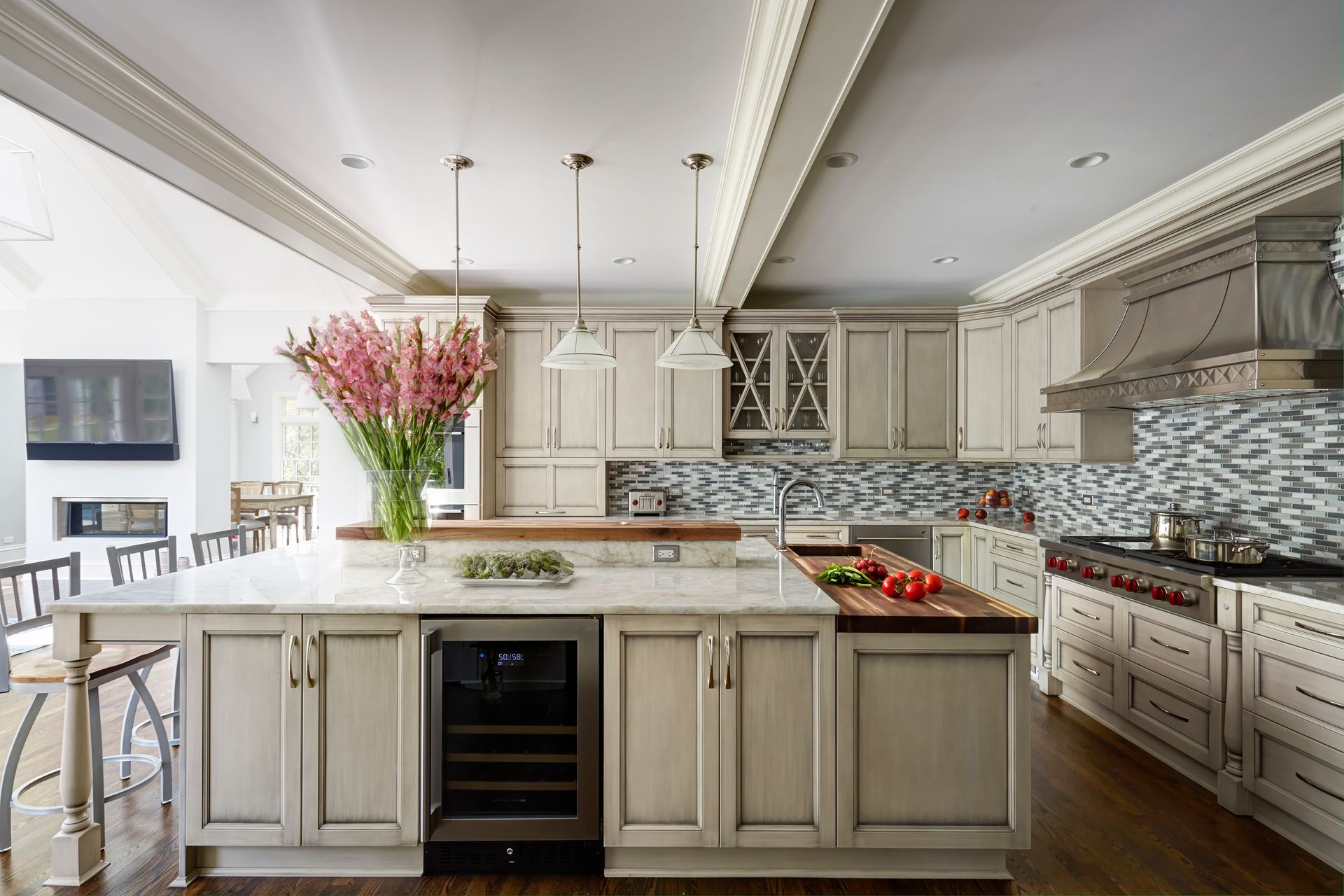 A large kitchen with white cabinets and a large island.