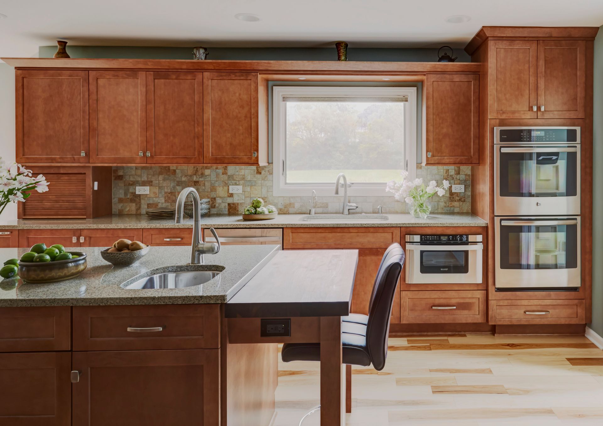 A kitchen with wooden cabinets and stainless steel appliances
