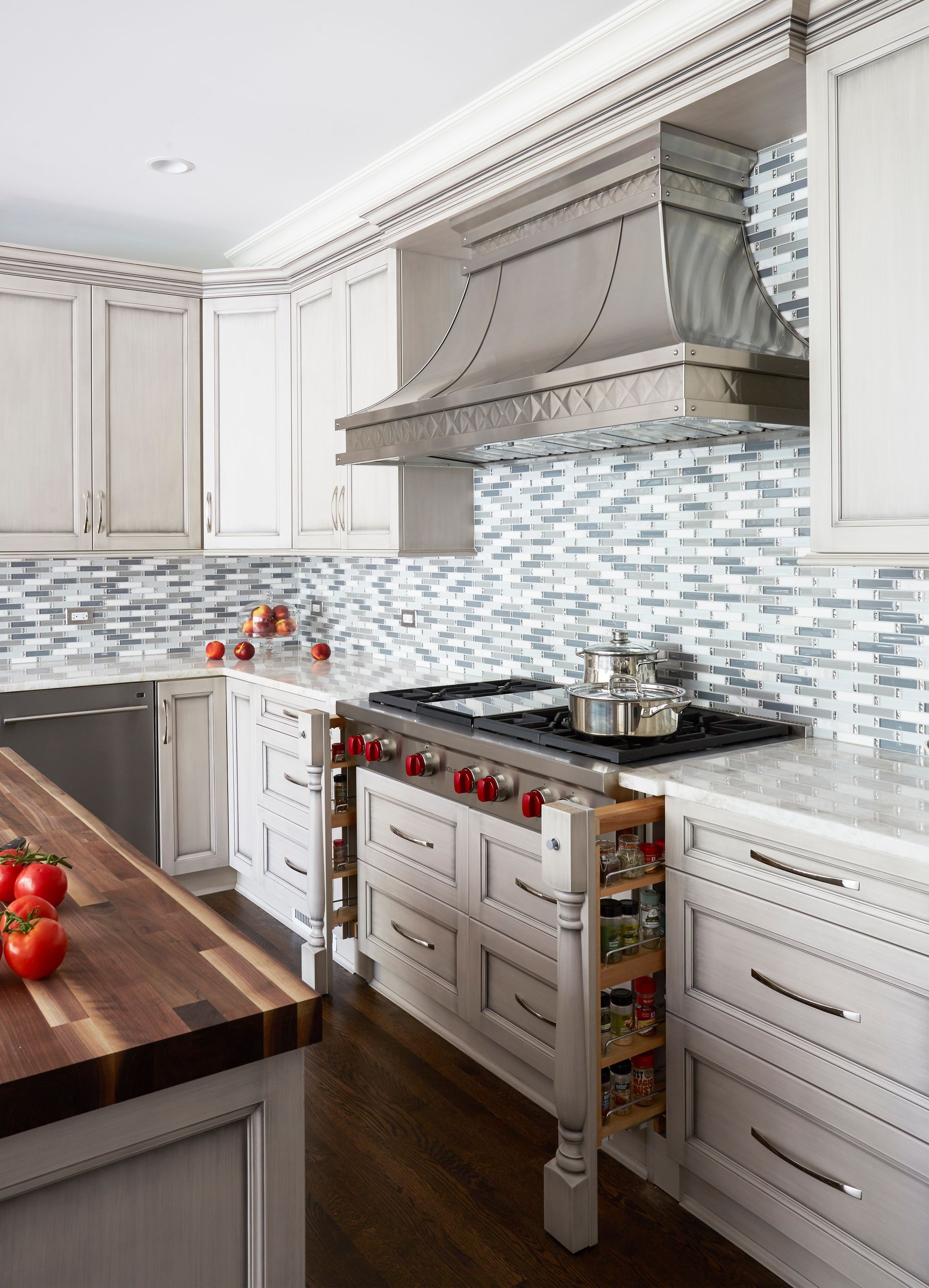A kitchen with white cabinets and a stove top oven