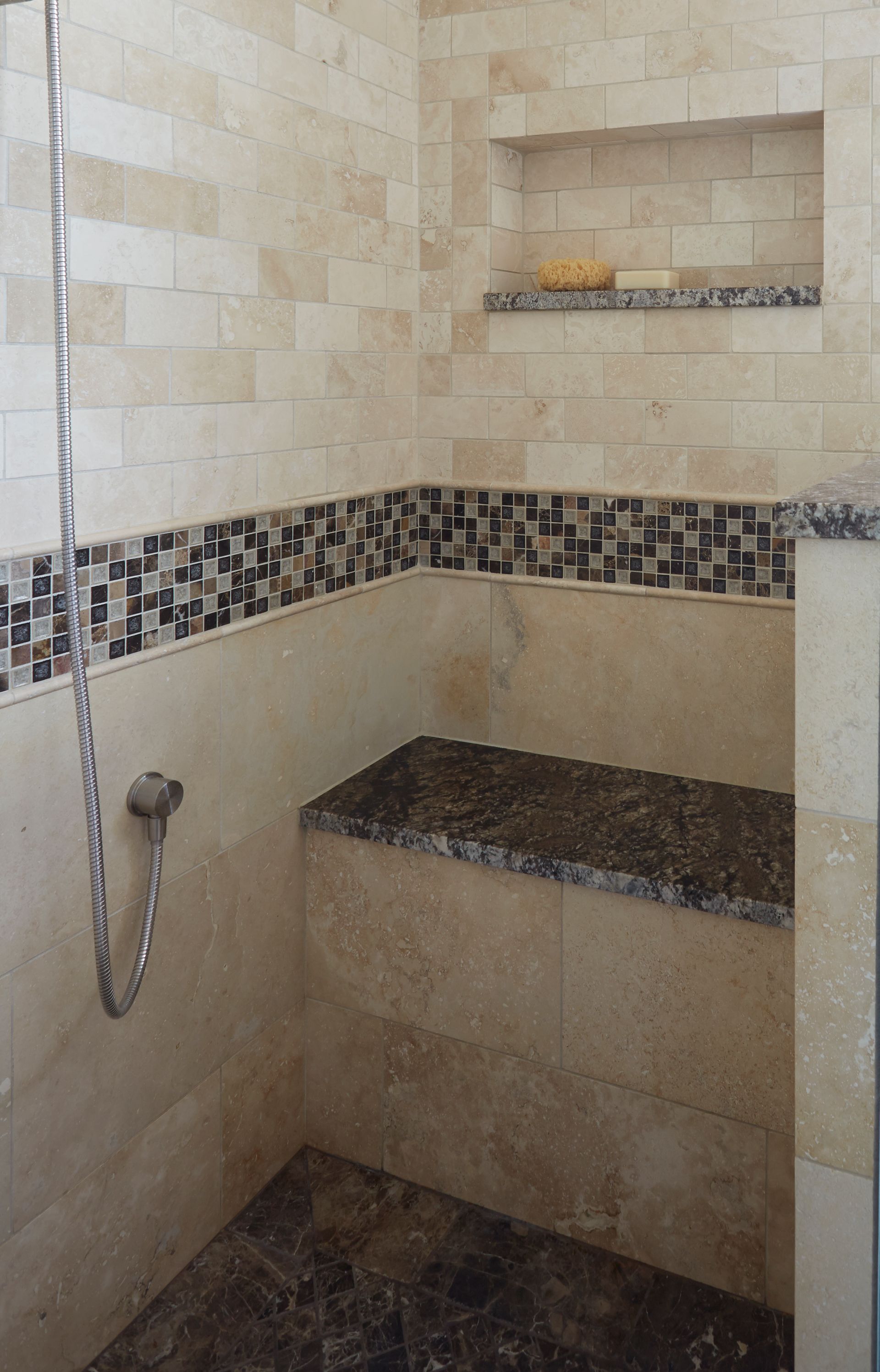A bathroom with a shower and a bench in it