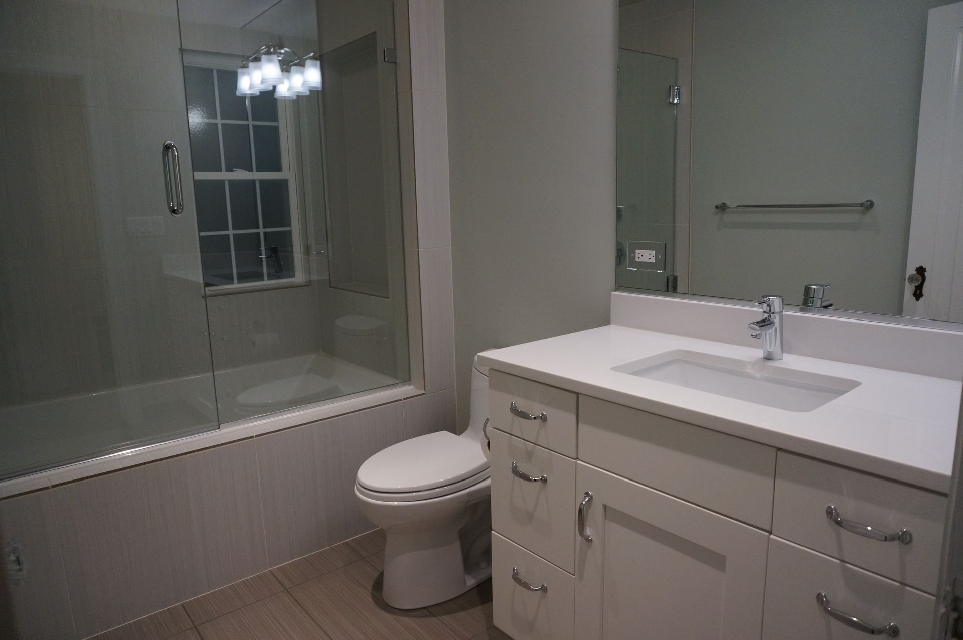 A bathroom with a toilet , sink , and bathtub.