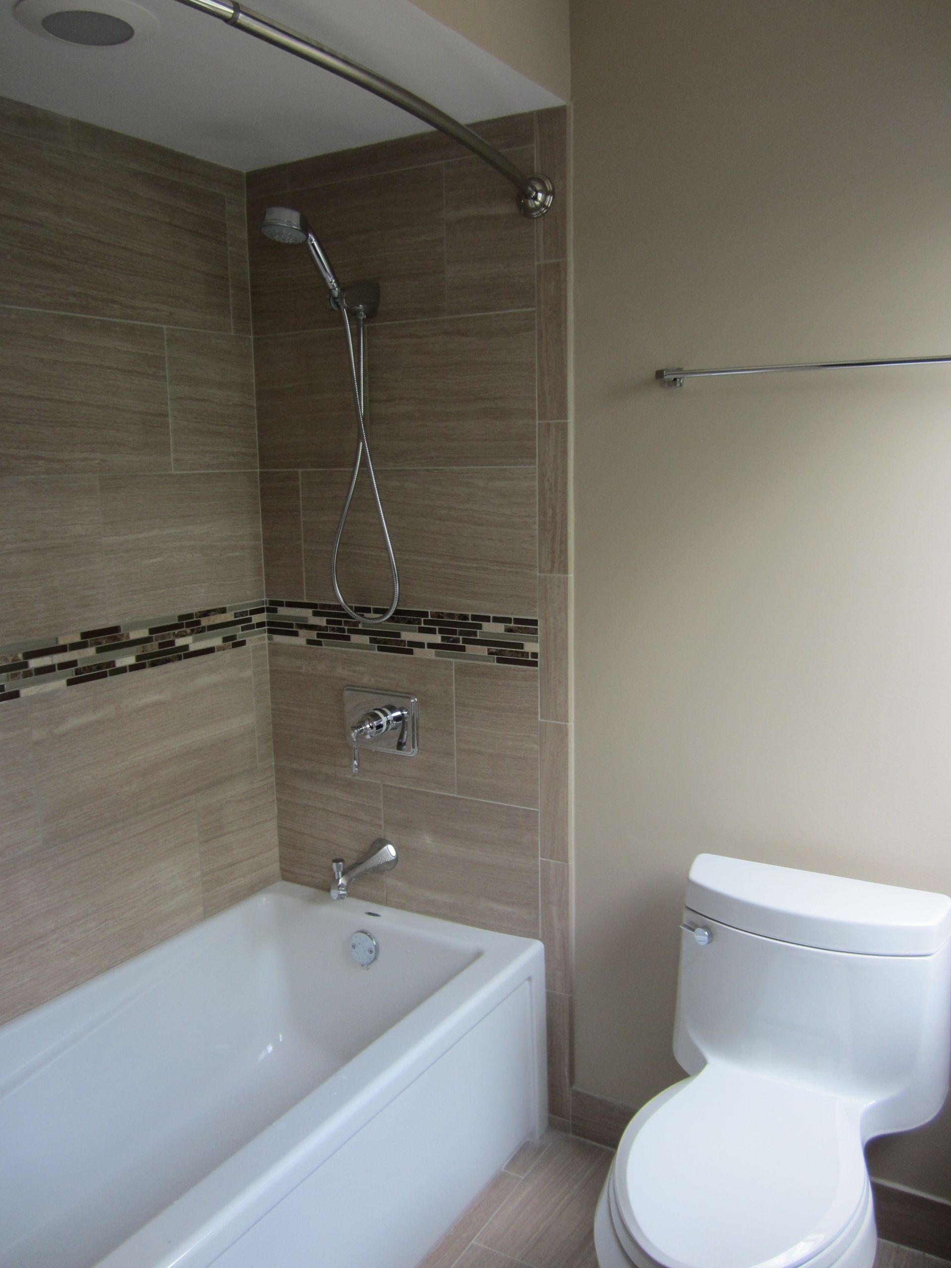 A bathroom with a toilet a bathtub and a shower