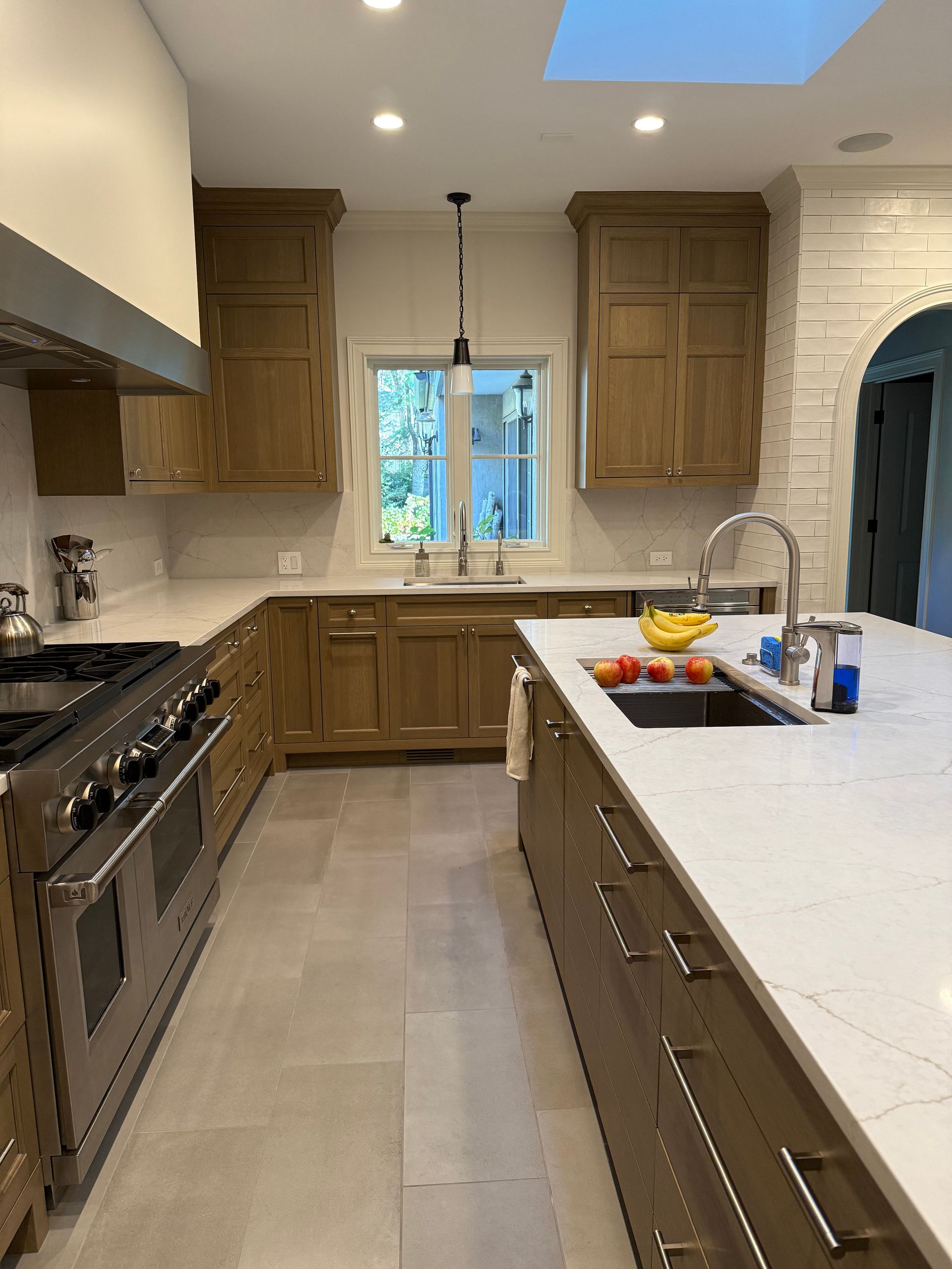 A kitchen with stainless steel appliances and wooden cabinets