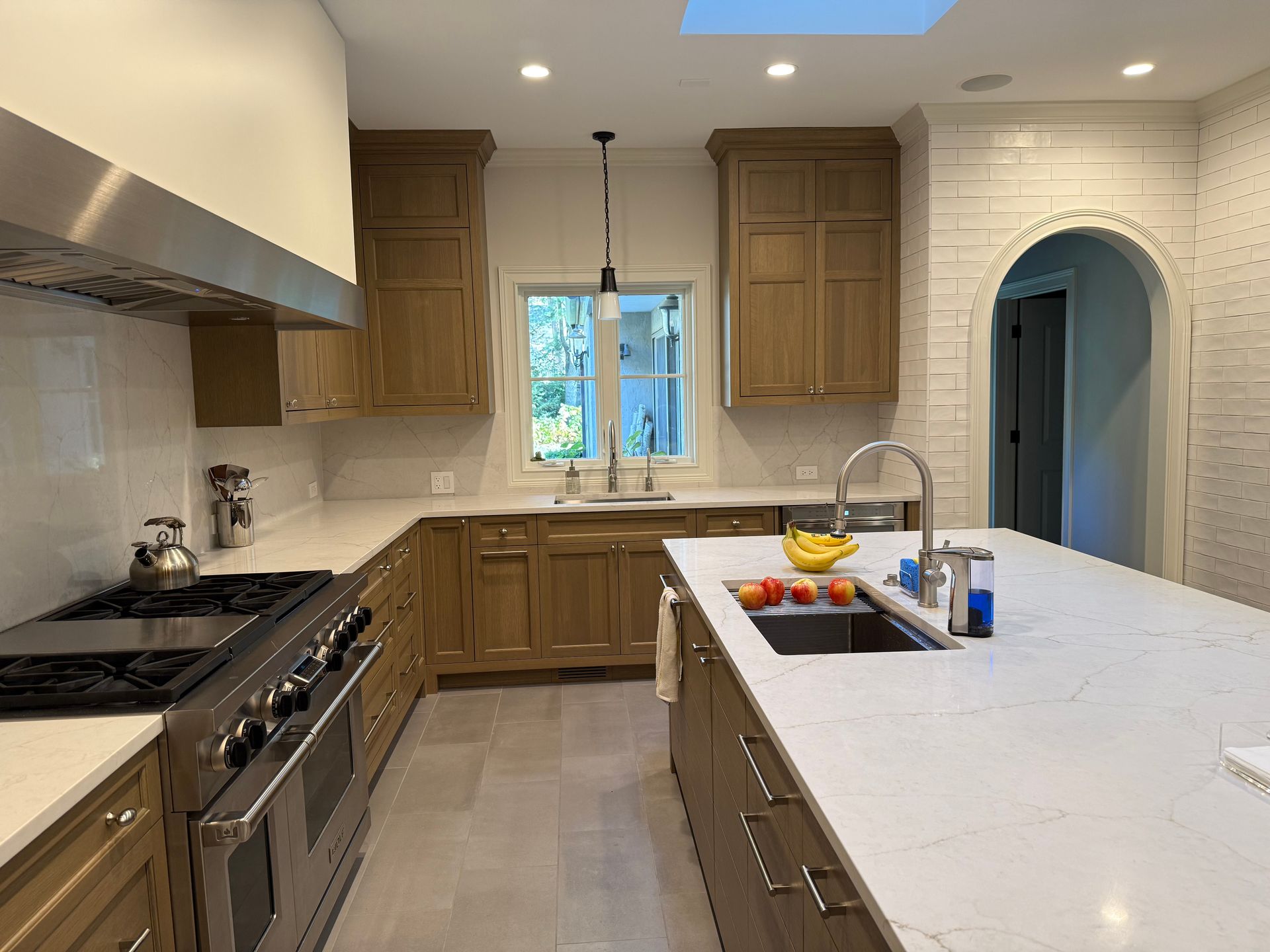 A kitchen with stainless steel appliances and wooden cabinets