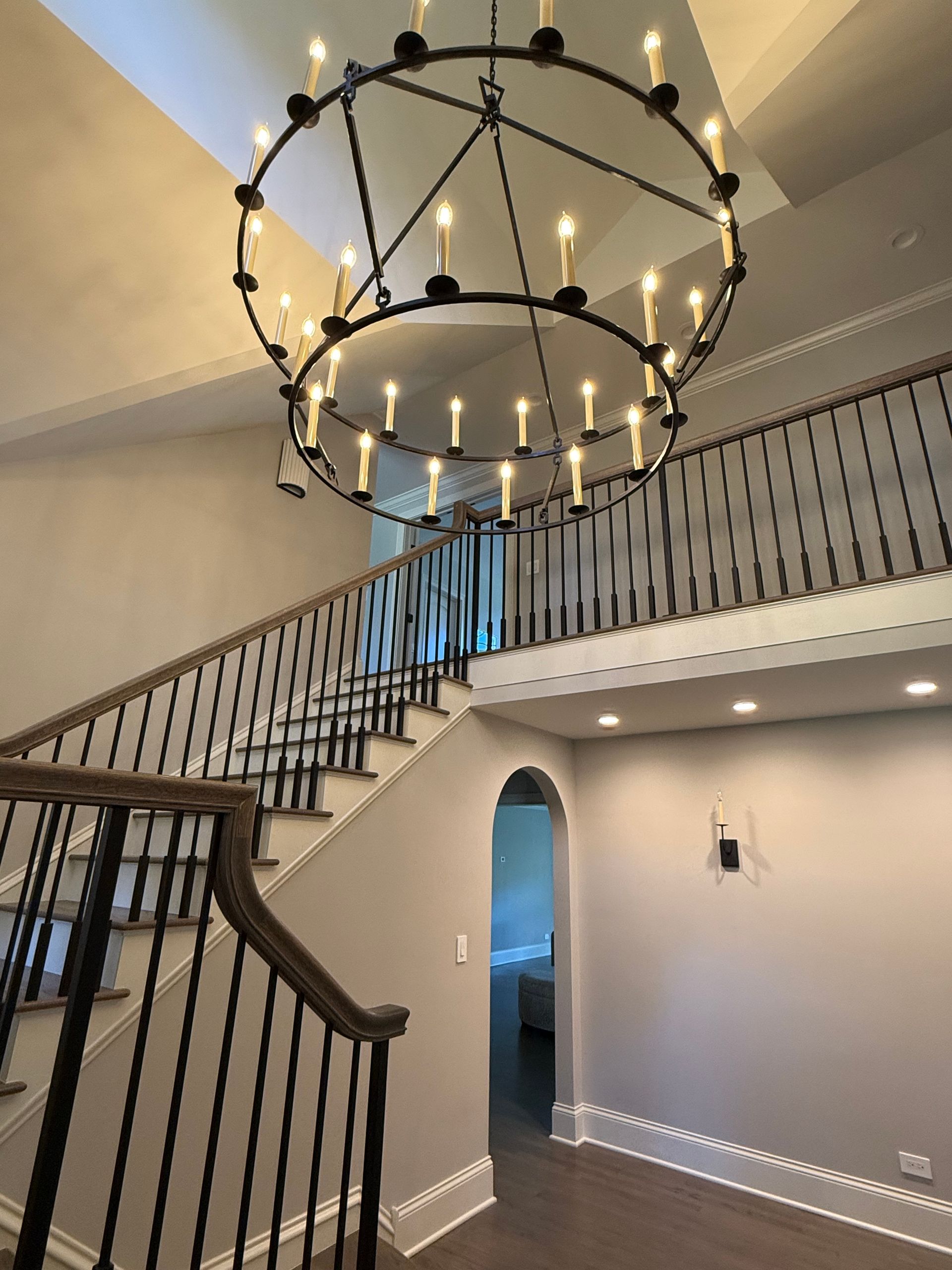 A staircase with a chandelier hanging from the ceiling