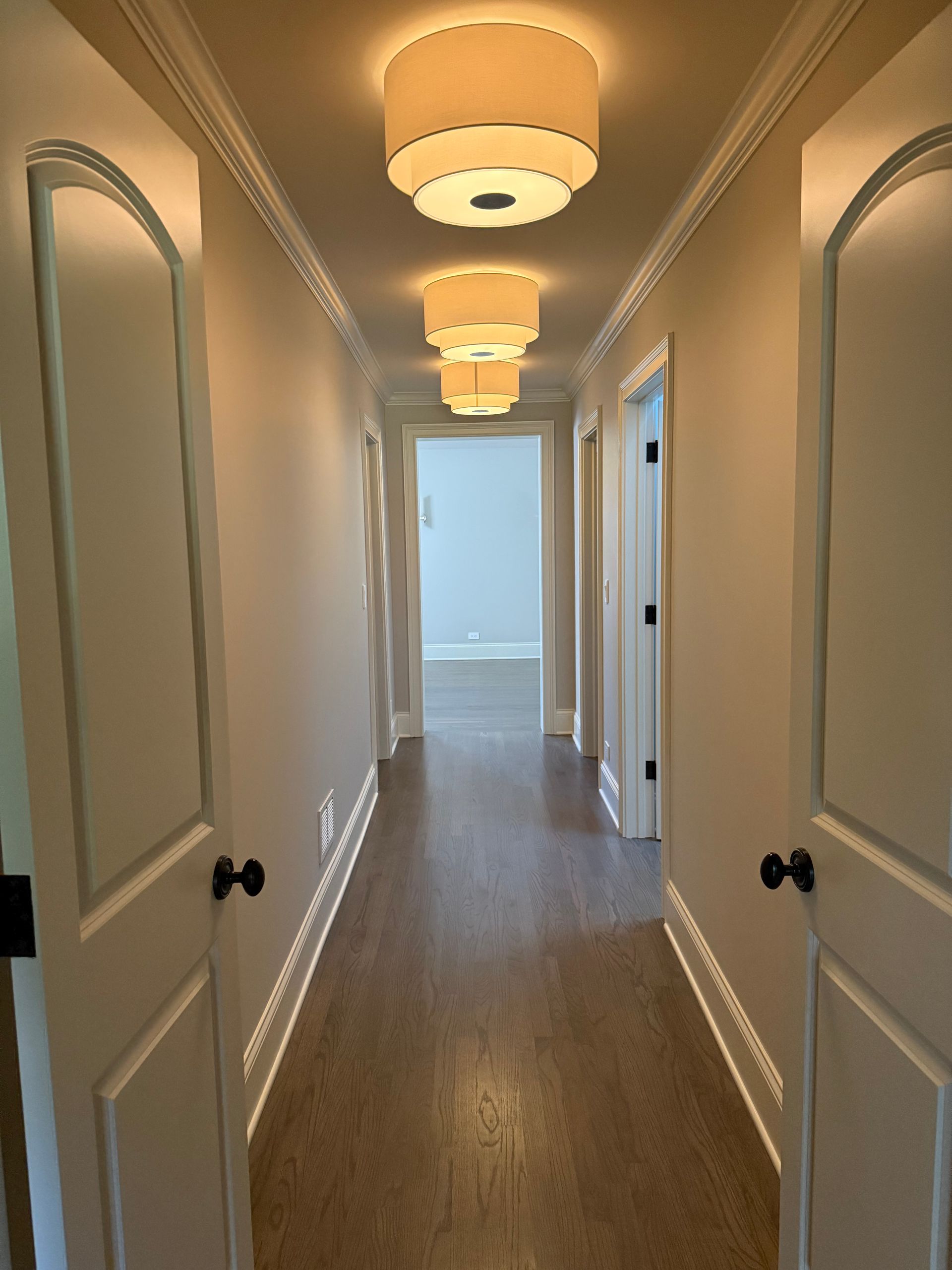 A long hallway with a lot of lights on the ceiling