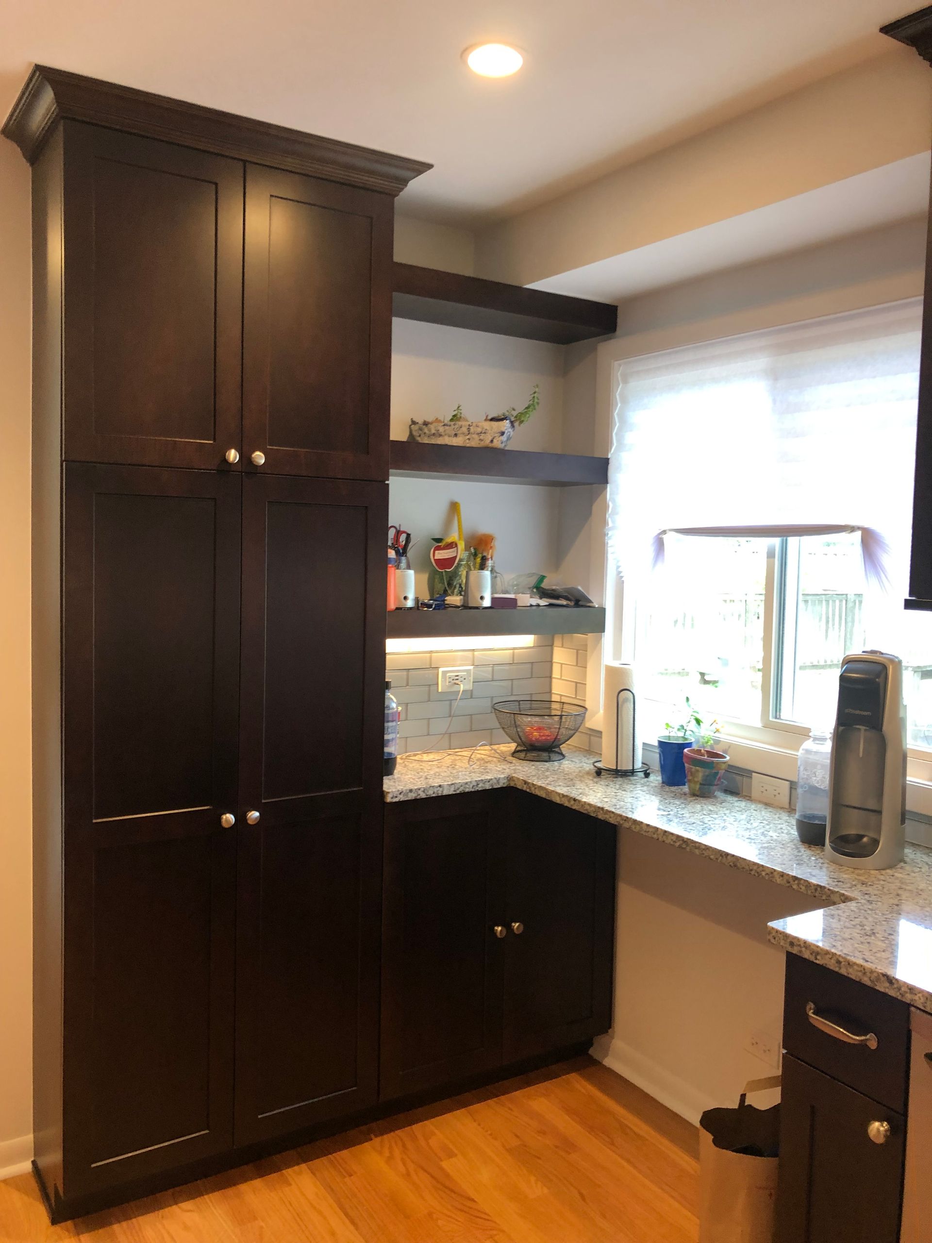 A kitchen with a lot of cabinets and a window