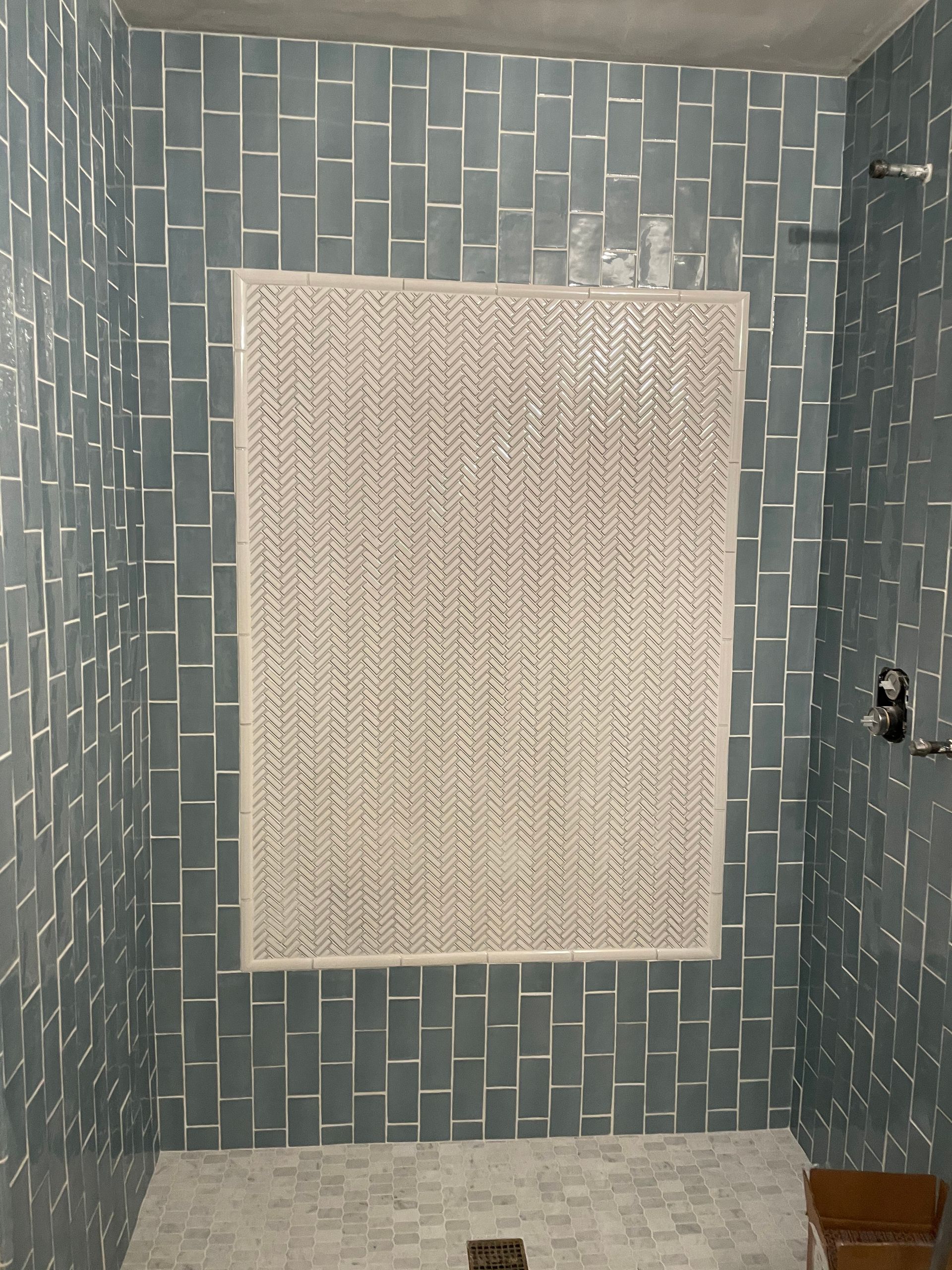 There is a picture on the wall in the shower.